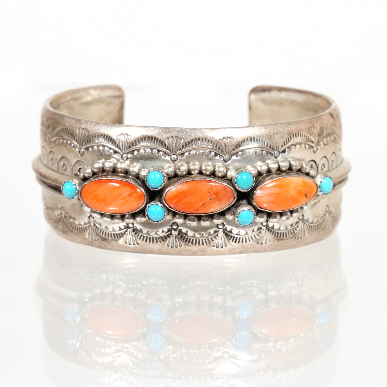 GARY NEZ NAVAJO STERLING CUFF BRACELET: Engraved and inset with oval coral & round turquoise stones, with fineness mark and maker's initials inside Provenance: The collection of a Newport, RI lady