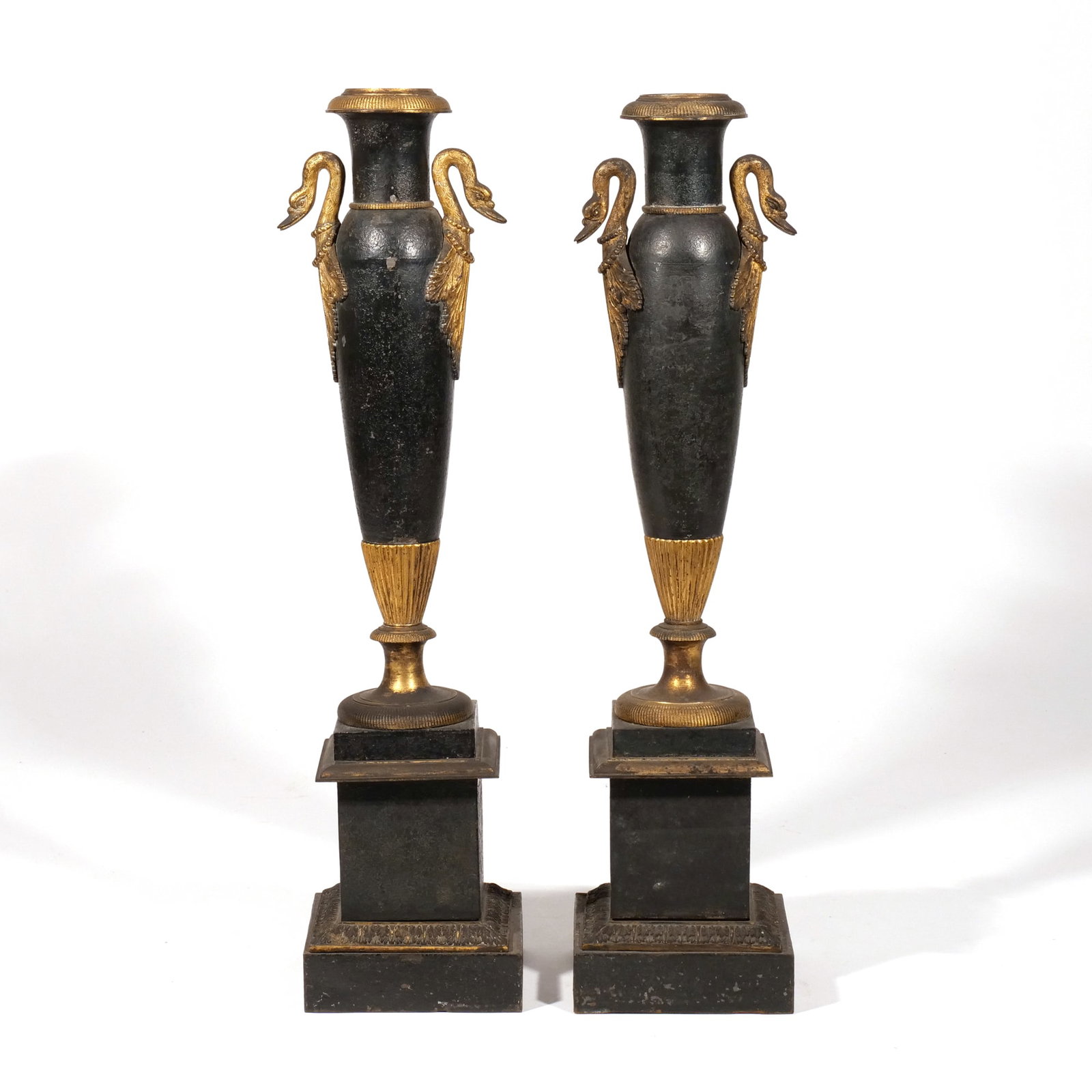 PAIR LOUIS XVI CANDLESTICKS/BOUILLOTTE LAMPS: Having swan necks at shoulder and ormolu accents, now, fitted for electricity with tole shades (reversible) h. 21 w. 5 in. Provenance: The Wood House, Essex until 1961 and Ham Spray House, Marlborough