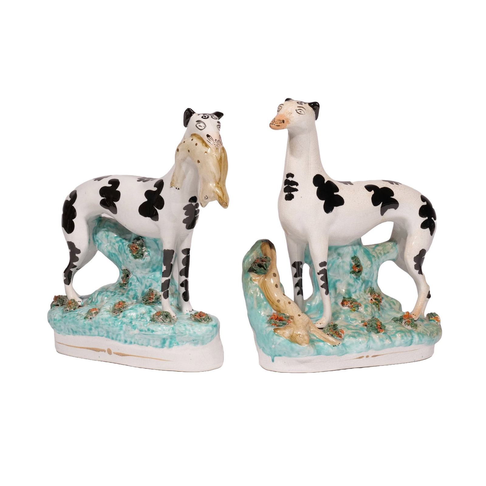 RARE PAIR of STAFFORDSHIRE GREYHOUND DOGS: Black and white ceramic hunting dog figurines, one with a hare in its mouth, the other with a hare at its feet, with turquoise decoration to bases h. 10-1/2 w. 9-1/2 in. Provenance: The Wood House, Es