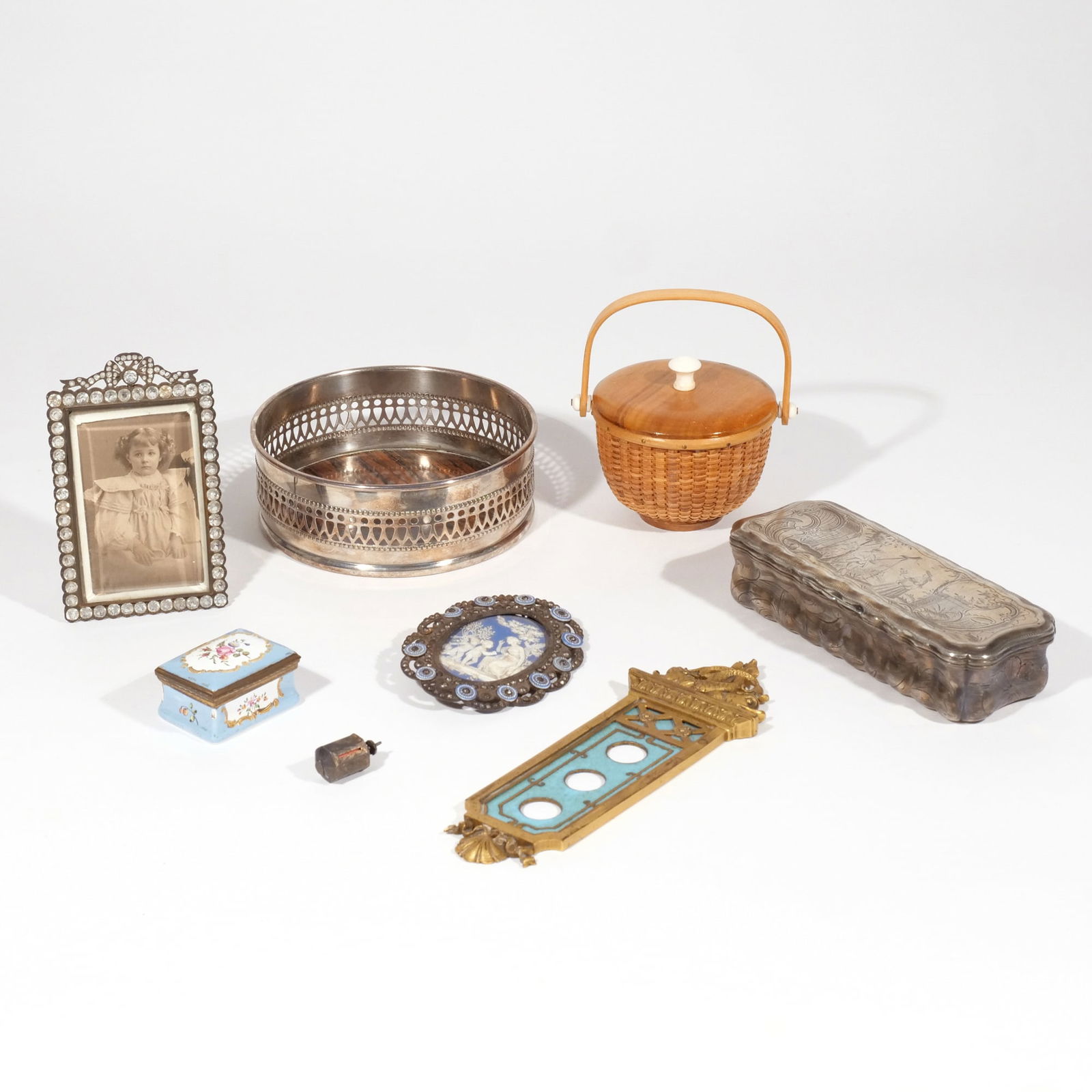 GROUP of DECORATIVE OBJECTS: Including a silver plated wine cooler, a brass engraved tobacco box with hinged lid (6 in. long), a small woven Nantucket Lighthouse-style basket with handle and lid, a bronze and enamel light switch