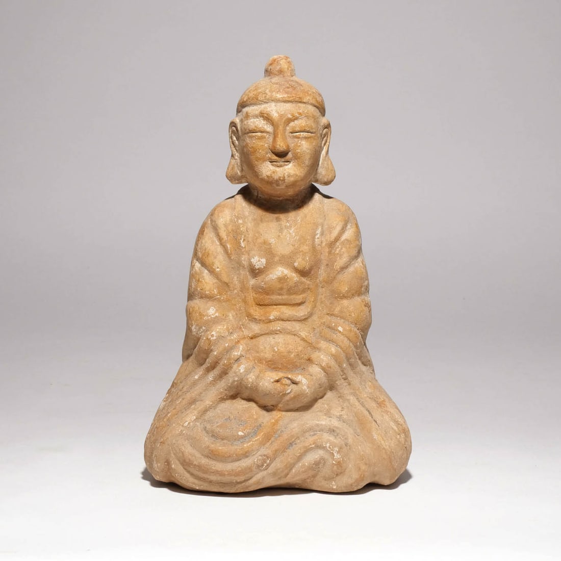 CHINESE CARVED STONE BUDDHA: Probably 19th century, the Buddha shown seated with his arms clasped in his lap h. 13 w. 8 d. 5 in. Provenance: Descent through the family of an avid collector and dentist, Armonk, NY [In Situ Item] T