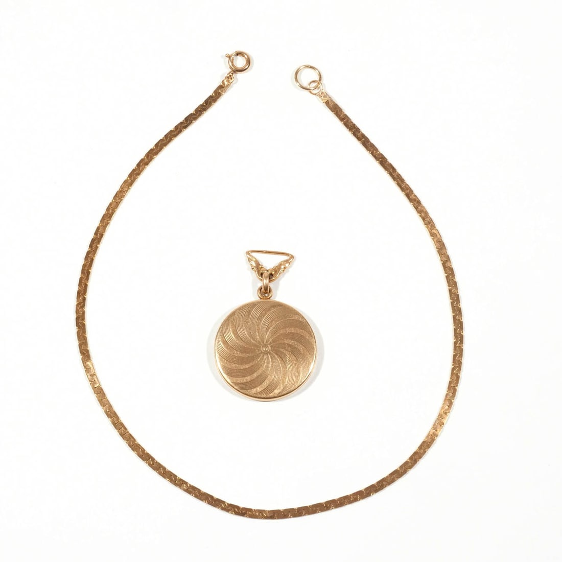 14k LOCKET: Locket with engraved design, opens to place two pictures, with 14k fineness mark, with a 14 in. chain, marked gold fill; 10.6g Provenance: Descent through the family of the consignor