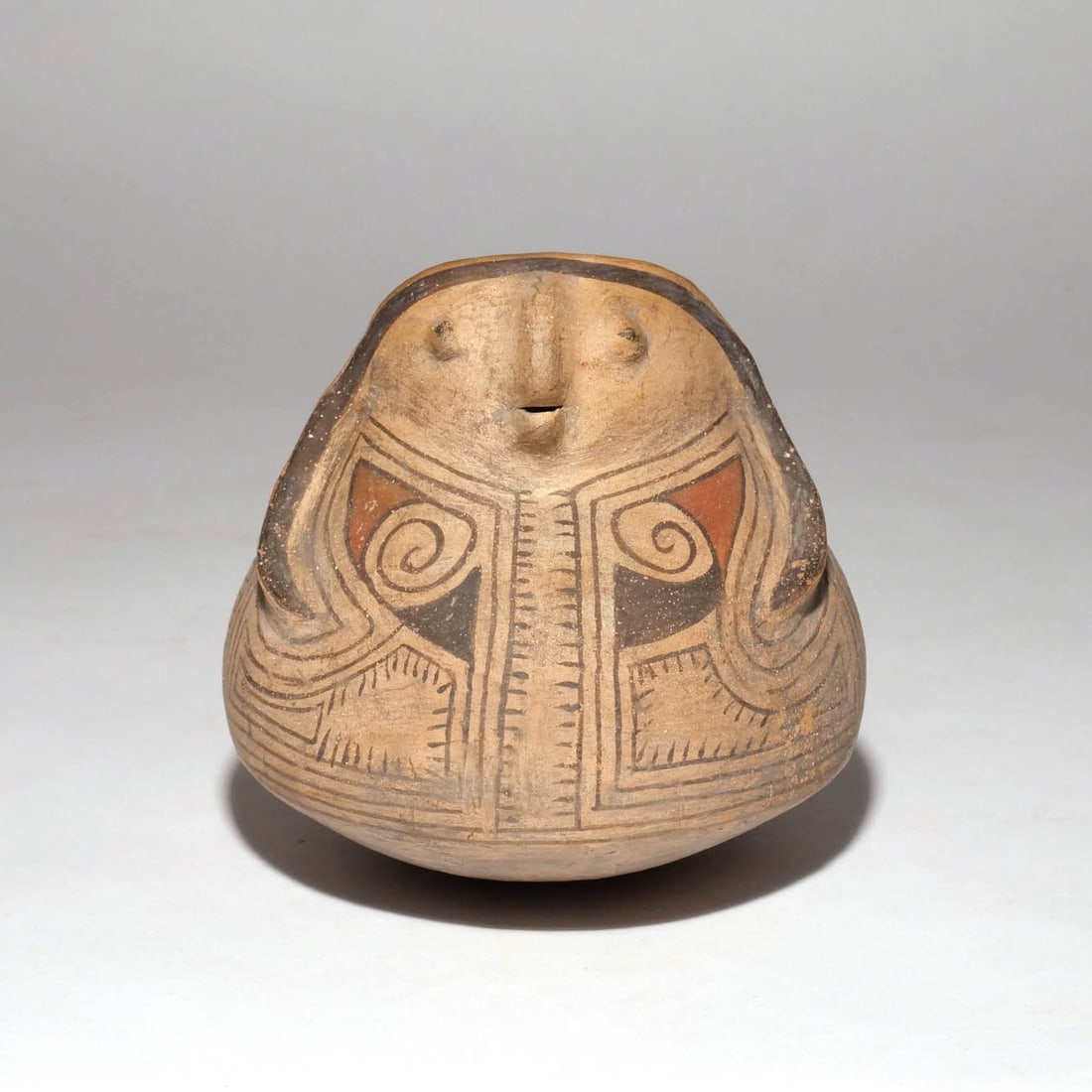 CASAS GRANDES POLYCHROME POTTERY FIGURE: Of ovoid shape, with female face and bichrome decoration h. 7 w. 8 d. 8 in. Provenance: Descent through the family of an avid collector and dentist, Armonk, NY [IN SITU ITEM] This item will not be on 