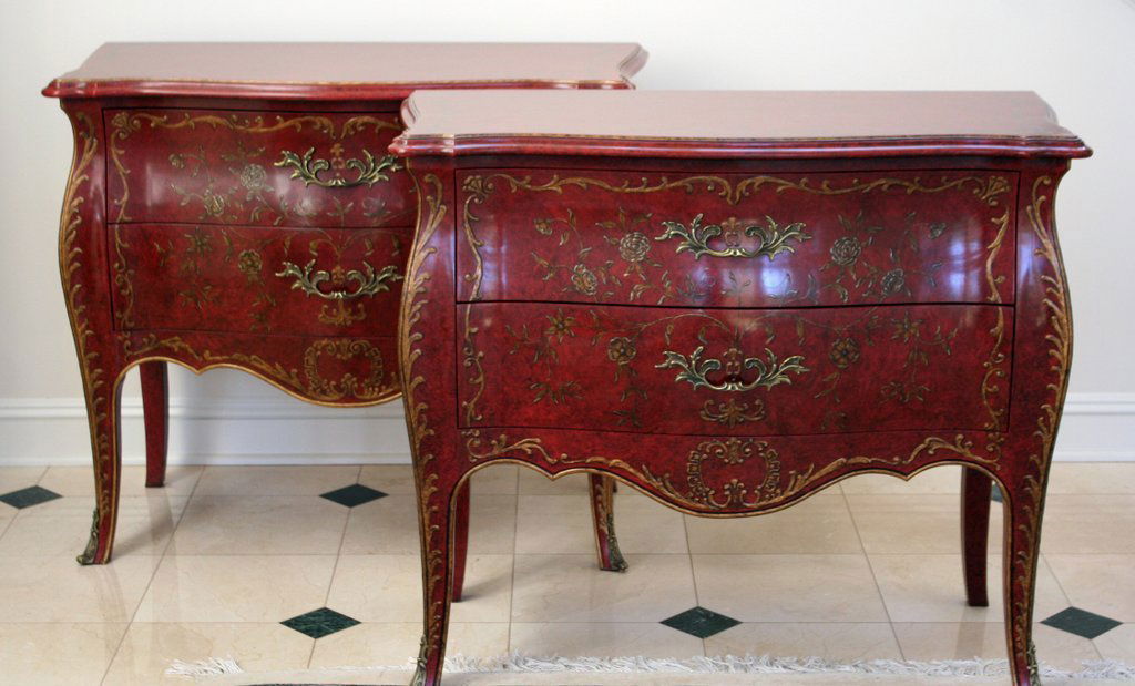 23) PAIR OF LOUIS XV-STYLE BOMBAY-FORM COMMODES: with ormolu mounts and painted decoration on a red ground, by John Widdicomb, Grand Rapids. H: 33 ½" W: 38" D: 18 ½"