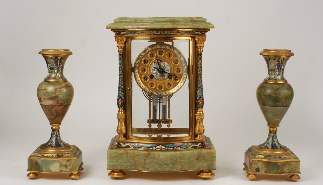 62) 19TH C. FRENCH GREEN ONYX & ORMOLU GARNITURE: with champlevé highlights, including a Time-and-Strike mantle clock marked "Samuel Marti, Medaille D'or Paris 1900" (H: 13 1/4" W: 9" D: 5 3/4"); and a pair of baluster-shaped candlesticks (H: 10 3/4