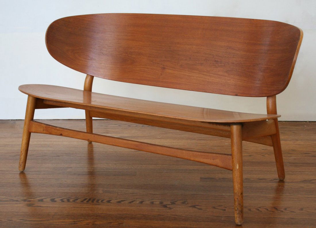 193) HANS WEGNER SHELL SETTEE BY FRITZ HANSEN,: DENMARK, molded teak plywood seat and back on beech legs, stamped mark "FH", original finish, 48"w x 25"d x 27"h, very good original condition H.27 ½", W.48"