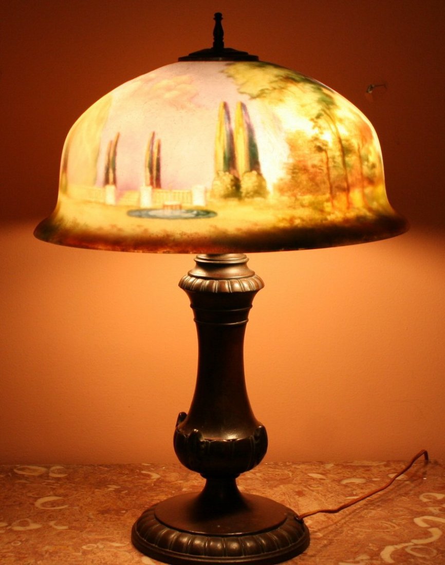 234) PAIRPOINT REVERSE PAINTED TABLE LAMP,: "Italian Garden Scene" (Malakoff, pp. 56 & 134), the helmet-shaped shade signed "G. Morley," on an urn-form base with gadrooned foot and neck, diameter of shade: 16" H: 22"