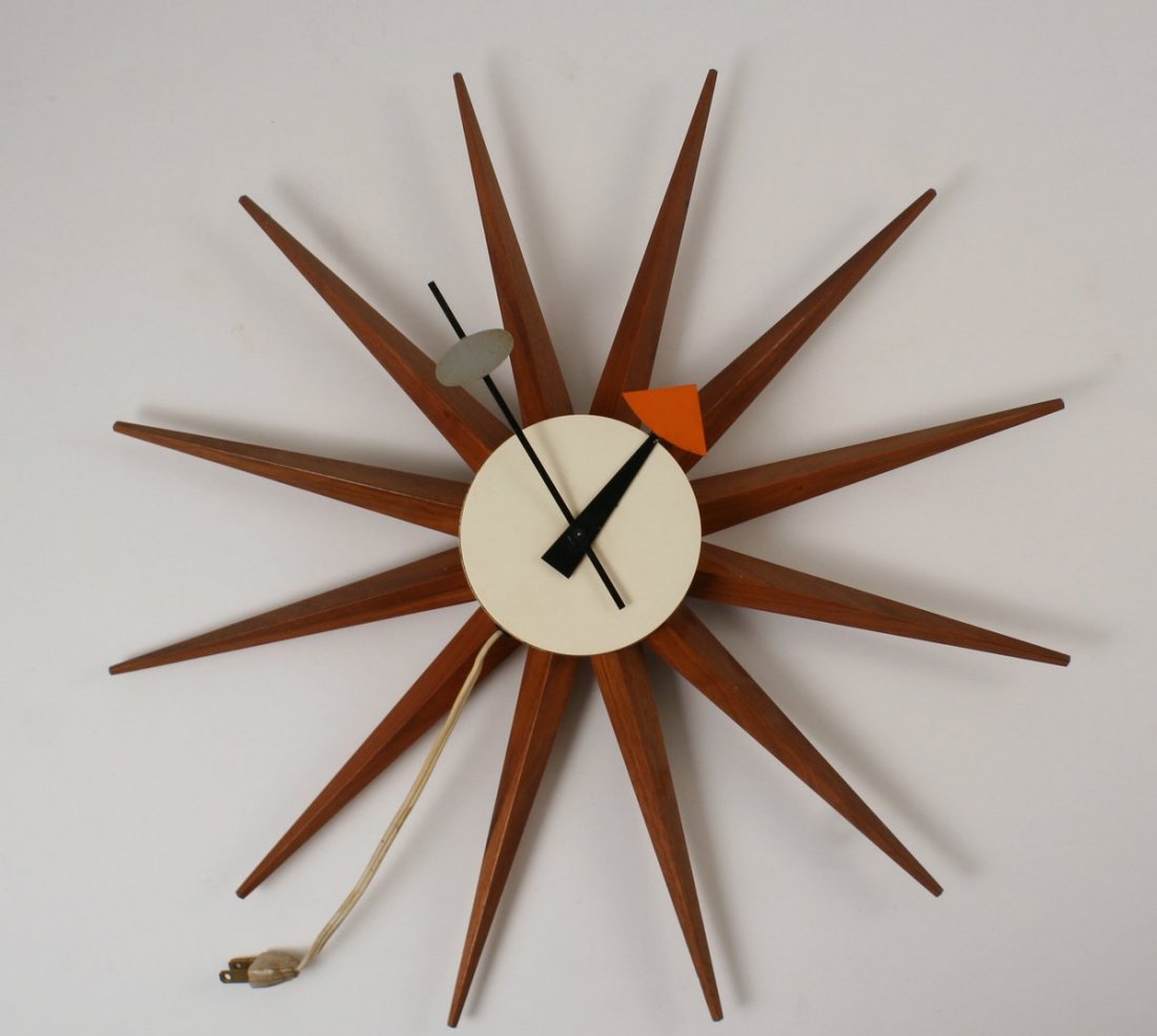 622) GEORGE NELSON WALNUT & ALUMINUM STARBURST WALL: CLOCK, diameter: 18", stamped "Howard Miller Clock Co Zeeland Mich.", serial numbered 2202, and with two paper labels on verso
