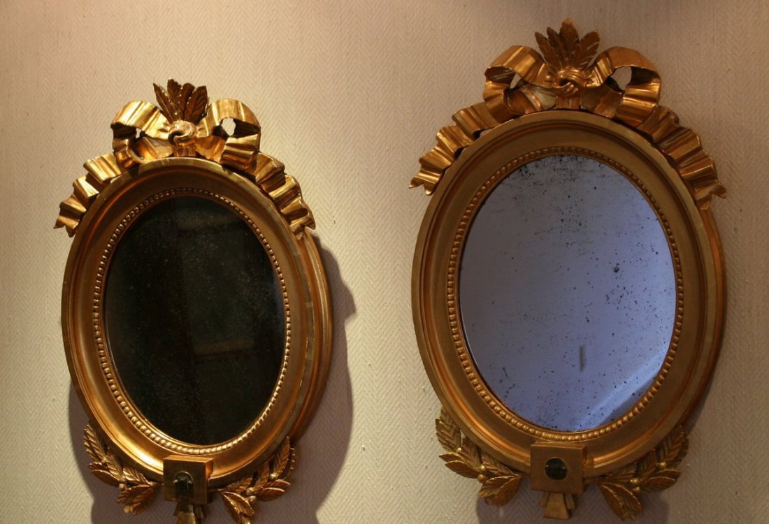 684) PAIR 19THC. SCANDINAVIAN GILTWOOD OVAL GIRANDOLES: with mirror backs, both missing candle-holders, H: 27" W: 18"