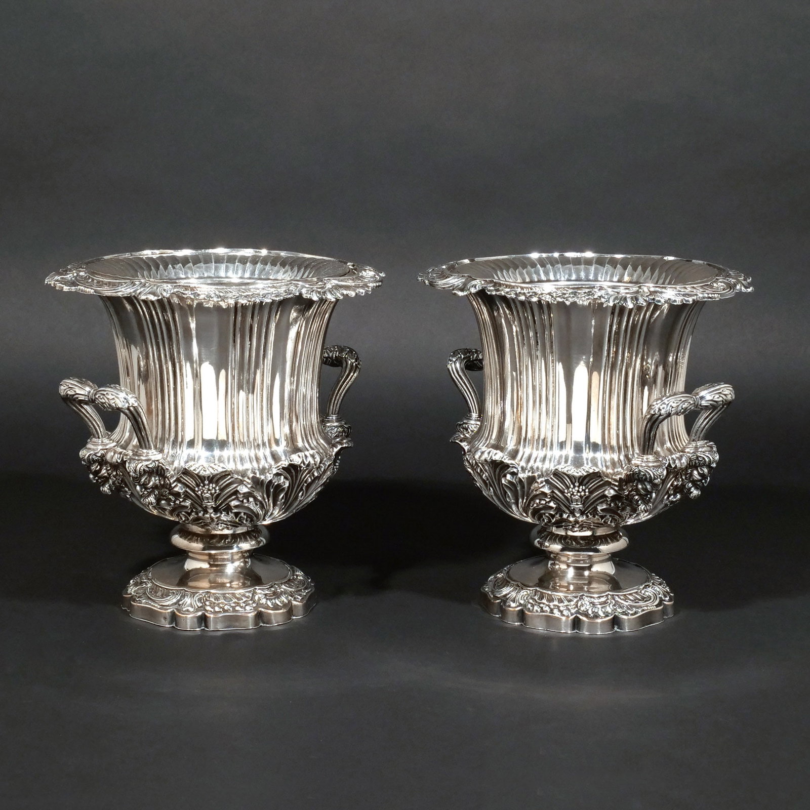 FINE PAIR of CLASSICAL SILVERPLATE WINE COOLERS: 19th or early 20th century, of campagna form with double handles having Bacchic faun-head supports, with foliate designs and classical scrollwork throughout, removable liners, no apparent maker's mark