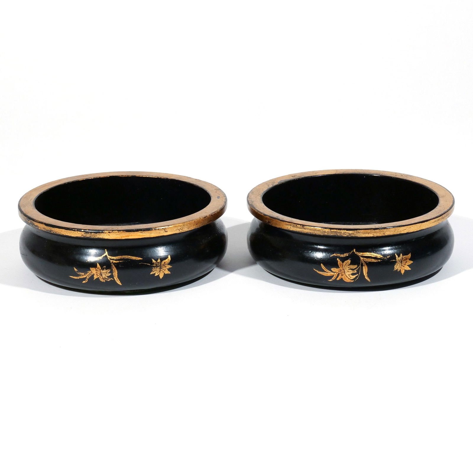 PAIR ENGLISH TURNED & LACQUERED WINE COASTERS: Early 19th century, with gilded rims and floral sprays on a black ground h. 2 dia. 6 in. (each) Provenance: Private collection, Stonington, CT