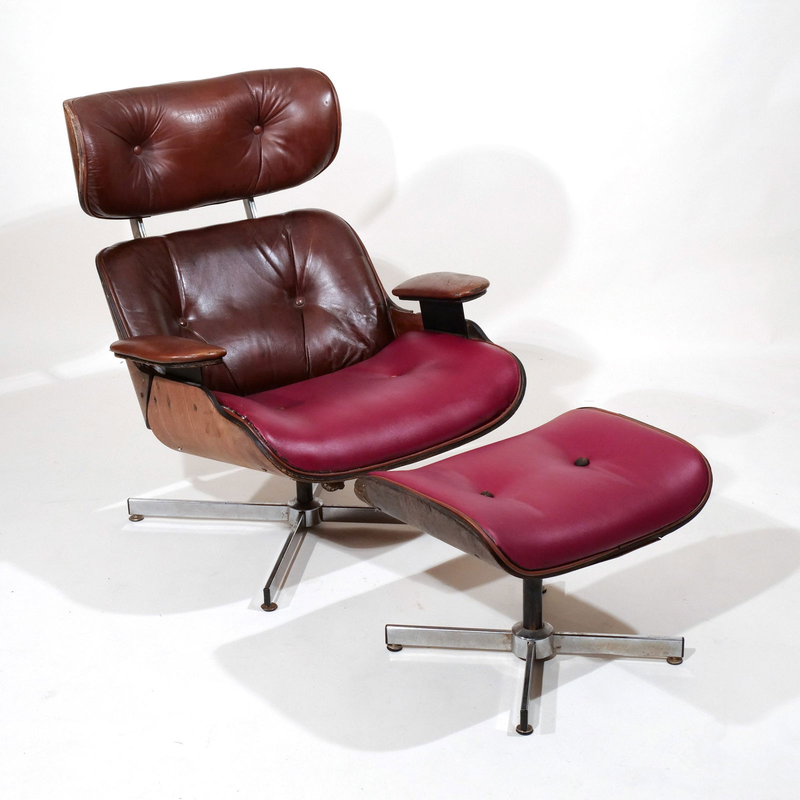 CHARLES & RAY EAMES LOUNGE CHAIR AND OTTOMAN: Having brown leather backrest, seat and ottoman upholstered in red leather h. 36 w. 31 d. 35 in. Provenance: Property of a gentlewoman, Mount Kisco, NY [In Situ Item] This item will not be on display