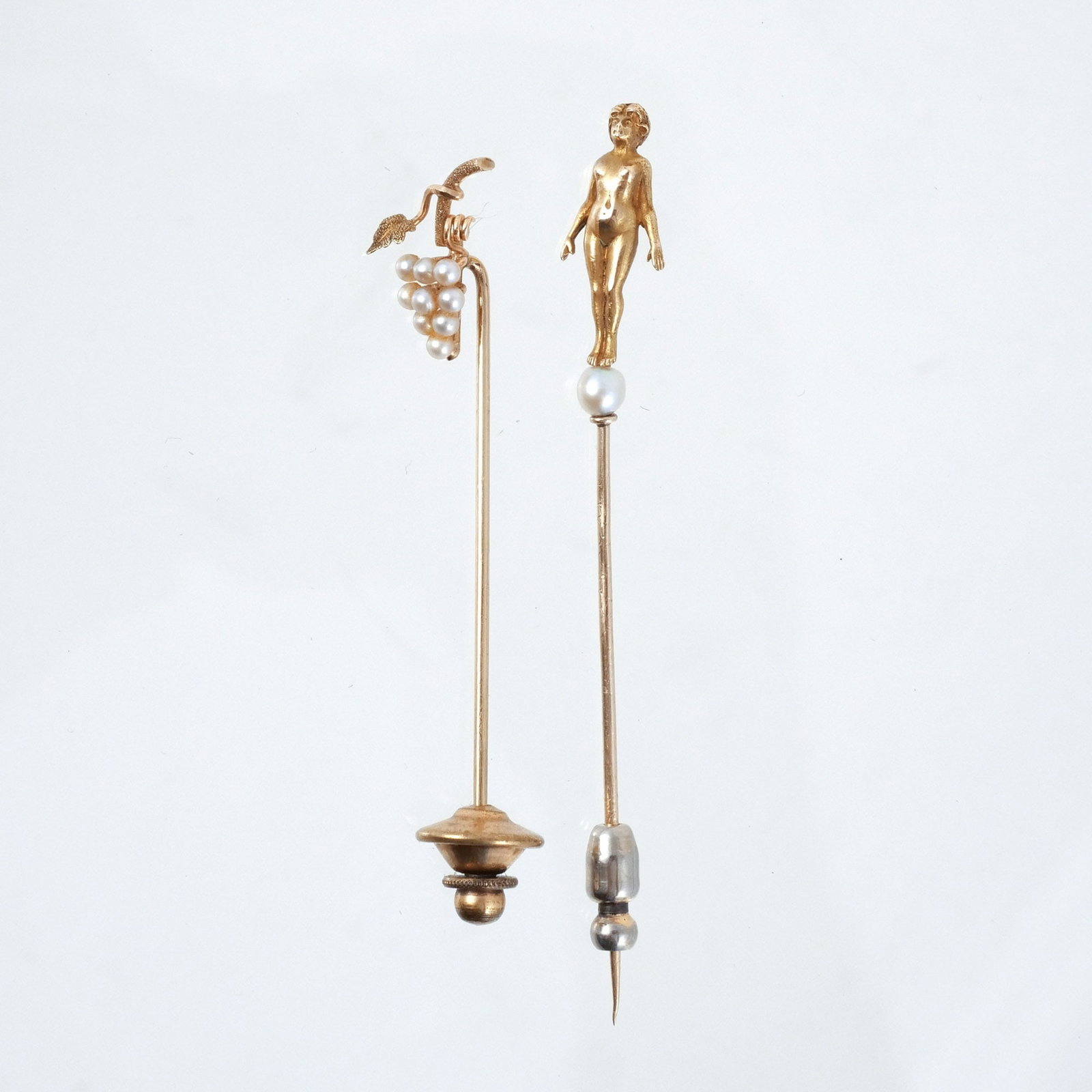 (2pc) 14k GOLD STICK PINS: One crested by full-length nude female, 3.7 grams total h. 3 in. Provenance: A Rye, NY estate