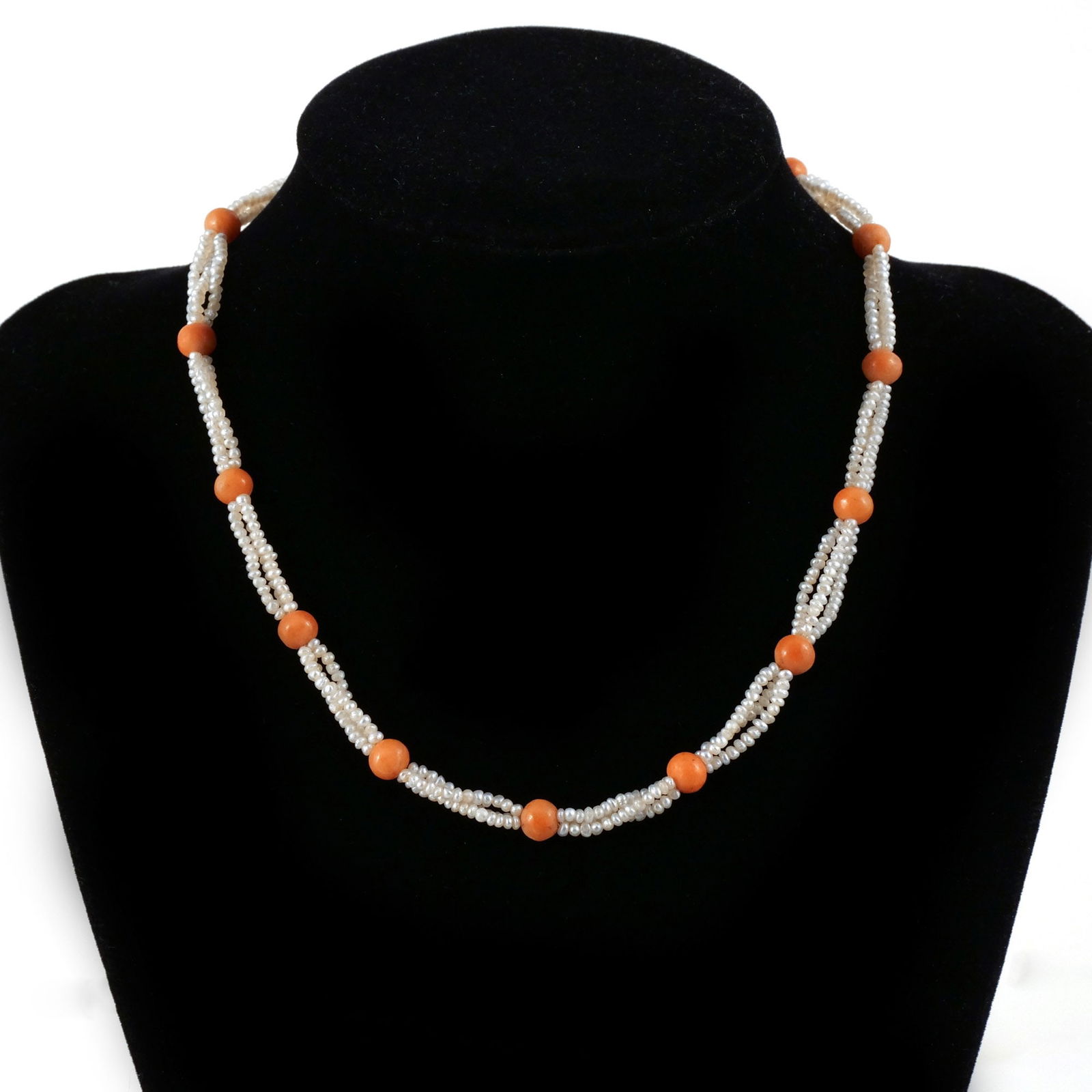 ANTIQUE LADY'S SEED PEARL NECKLACE: Station necklace with triple torsade seed pearls between round coral color beads, L. 14 in. Provenance: A North Salem, NY estate