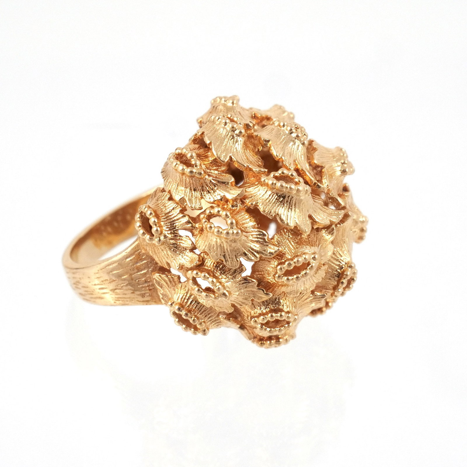 18k GOLD DOMED LEAF CLUSTER RING: Open work textured gold, marked '750' and with conjoined monogram 'AK', l. 1 in., size 7-1/2, 19 g Provenance: Descended through the family of the current owner, private collection, Pound Ridge, NY