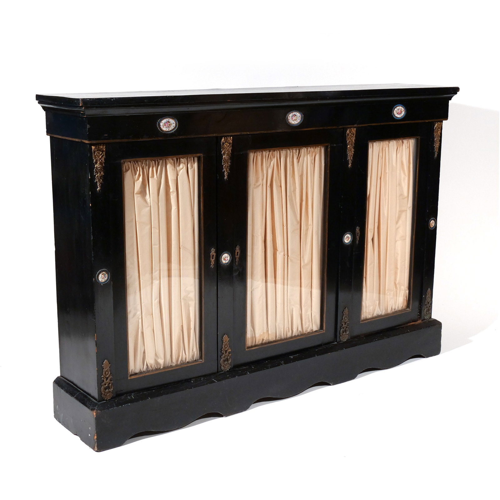 LOUIS XVI-STYLE CONSOLE CABINET: 19th century, in black paint with Sevres-style porcelain and ormolu mounts h. 42 w. 61 d. 12-1/4 in. Provenance: Descent through a prominent Manhattanite's estate [In Situ Item] This item will not be