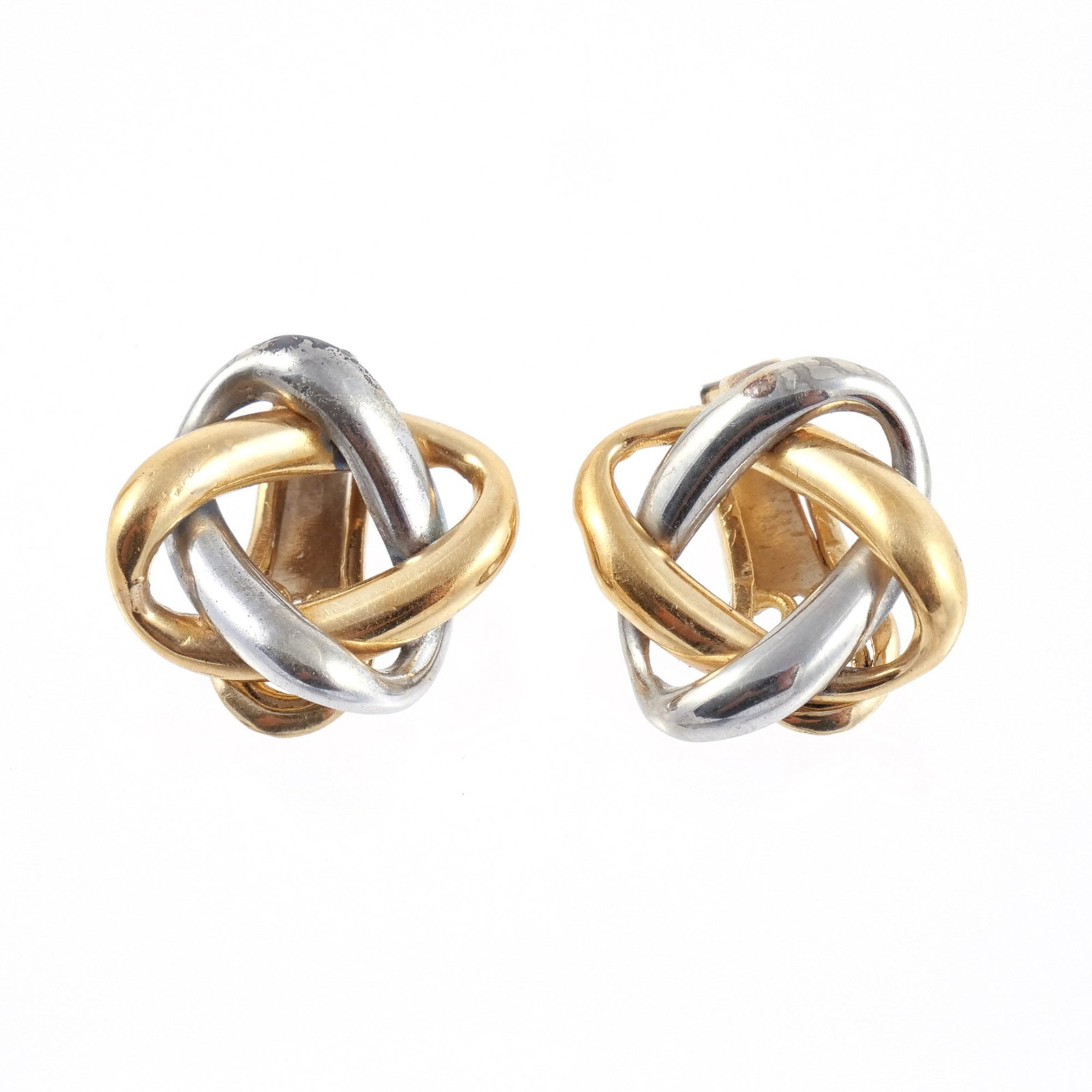 PAIR of 18K TWO-TONE GOLD EAR CLIPS: Composed of two interlocking rings, one in 14k yellow gold and the other in 14k white gold, marked '750' and with possible maker's mark, l. 1 in., 12.8 g total weight Provenance: Descent through a pro