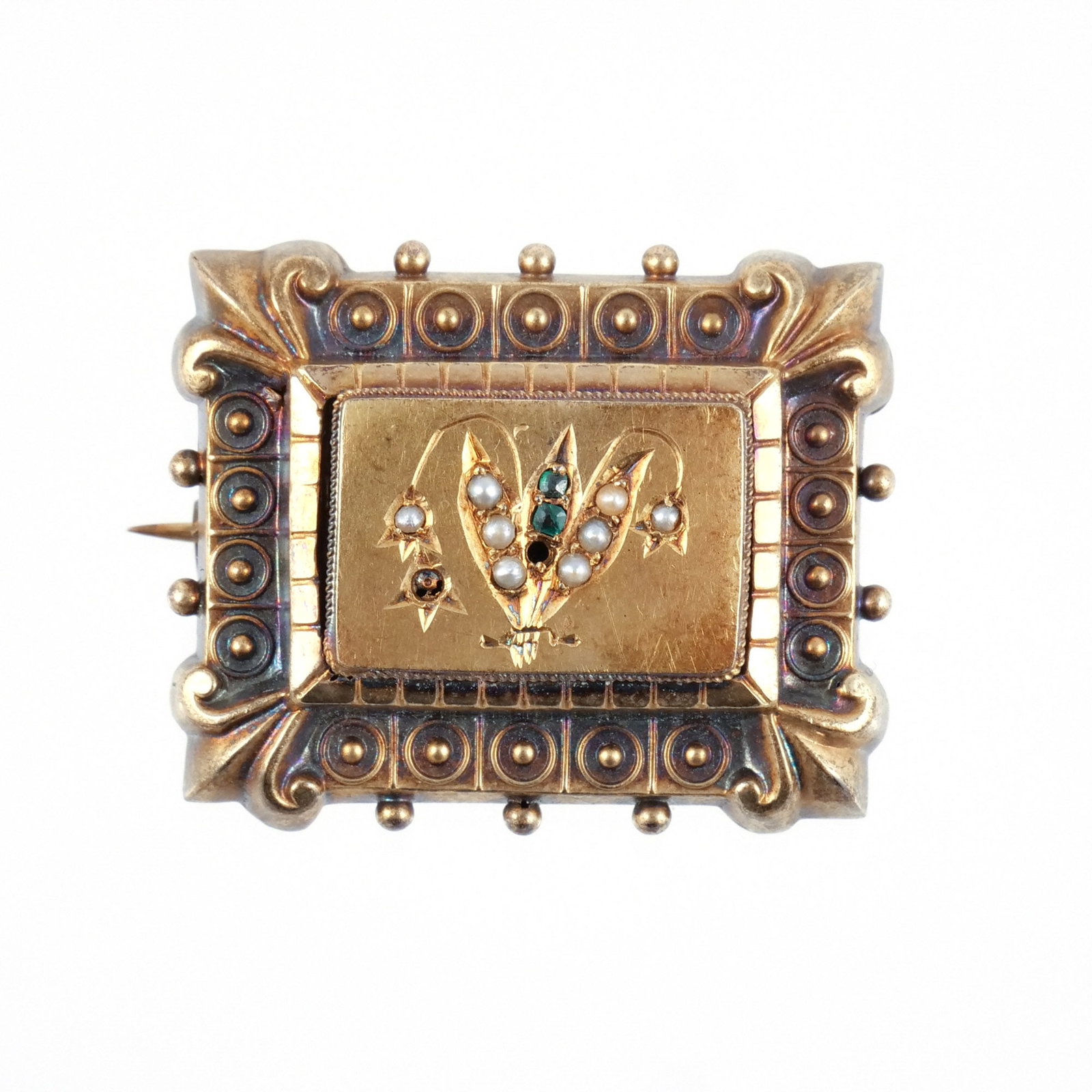 VICTORIAN 14K GOLD MOURNING PIN: With a stepped border of applied gold beading and fleur de lis motifs centering a floral spray in relief set with seed pearls and small green stones, unmarked but tests as 14k, 10.8 g total weight h.