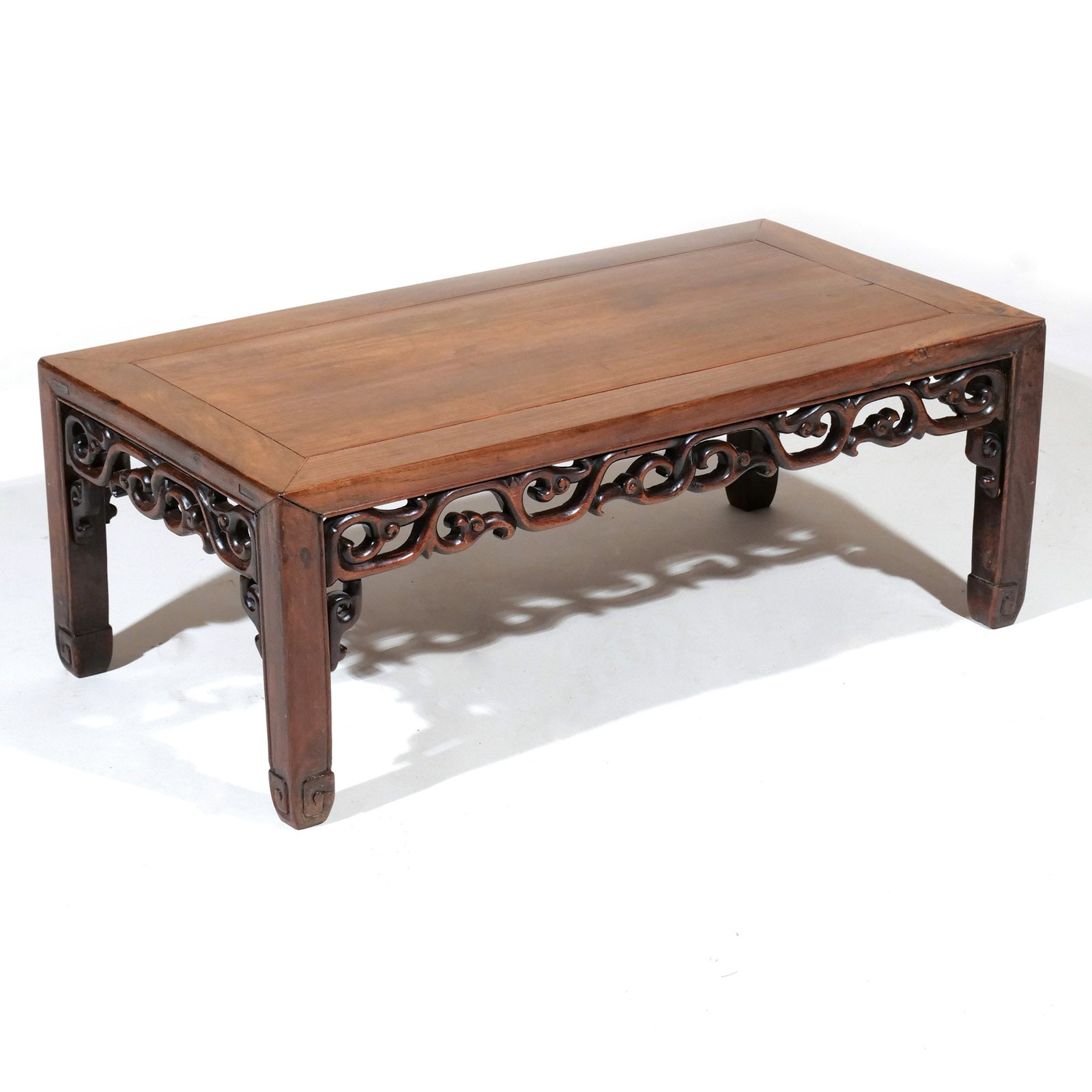 CHINESE HONGMU LOW TABLE: 19th century, with through-carved scrollwork aprons h. 11 w. 30 d. 15 in. Provenance: A prominent New Canaan, CT estate [In Situ Item] This item will not be on display in our saleroom during the previ