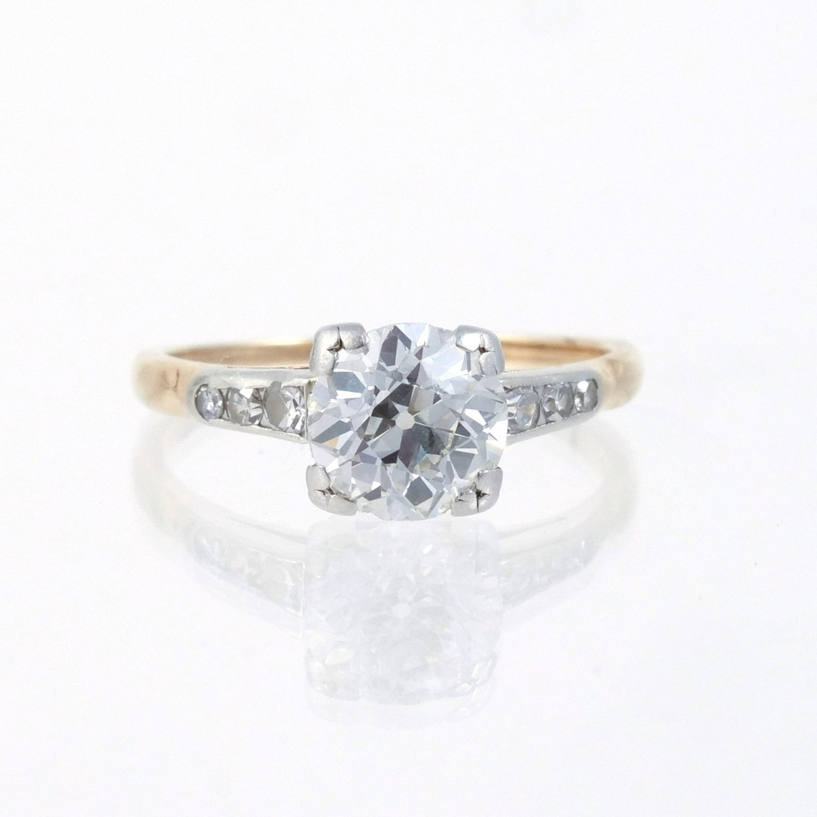 APPROX. 1 CT ROUND BRILLIANT DIAMOND RING: Mounted in 14k gold with three melee diamonds on either side, size 4-1/2, 1.7 g Provenance: Descent through a deceased former U.S. Ambassador's estate