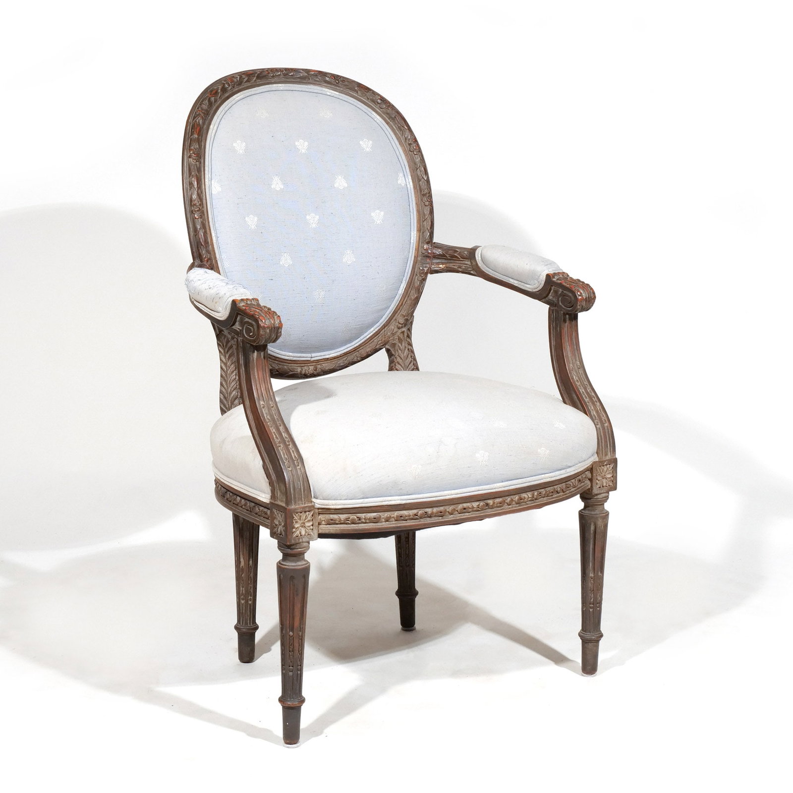 LOUIS XVI-STYLE CARVED FAUTEUIL: Having upholstered backrest, seat and arm pads, seat height 17-1/2 in. h. 37-1/2 w. 24 d. 21 in. Provenance: Descent through a prominent Greenwich, CT family [In Situ Item] This item will not be on