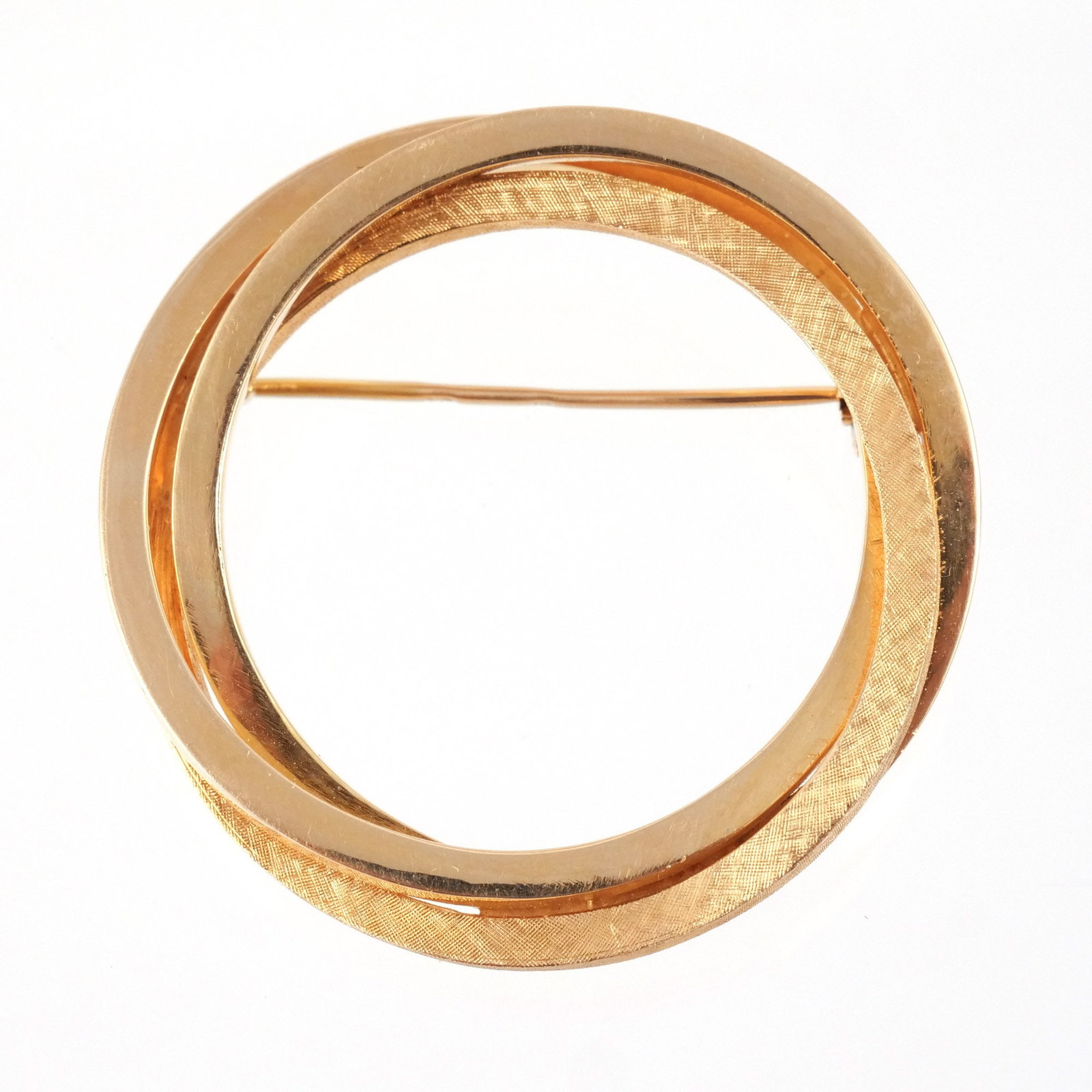 18K GOLD TRIPLE CIRCLE BROOCH: Composed of interlocking polished and textured rings, unmarked but tests at 18k, 16 g dia. 1-5/8 in. Provenance: The estate of a noted architect and bibliophile, Rye, NY