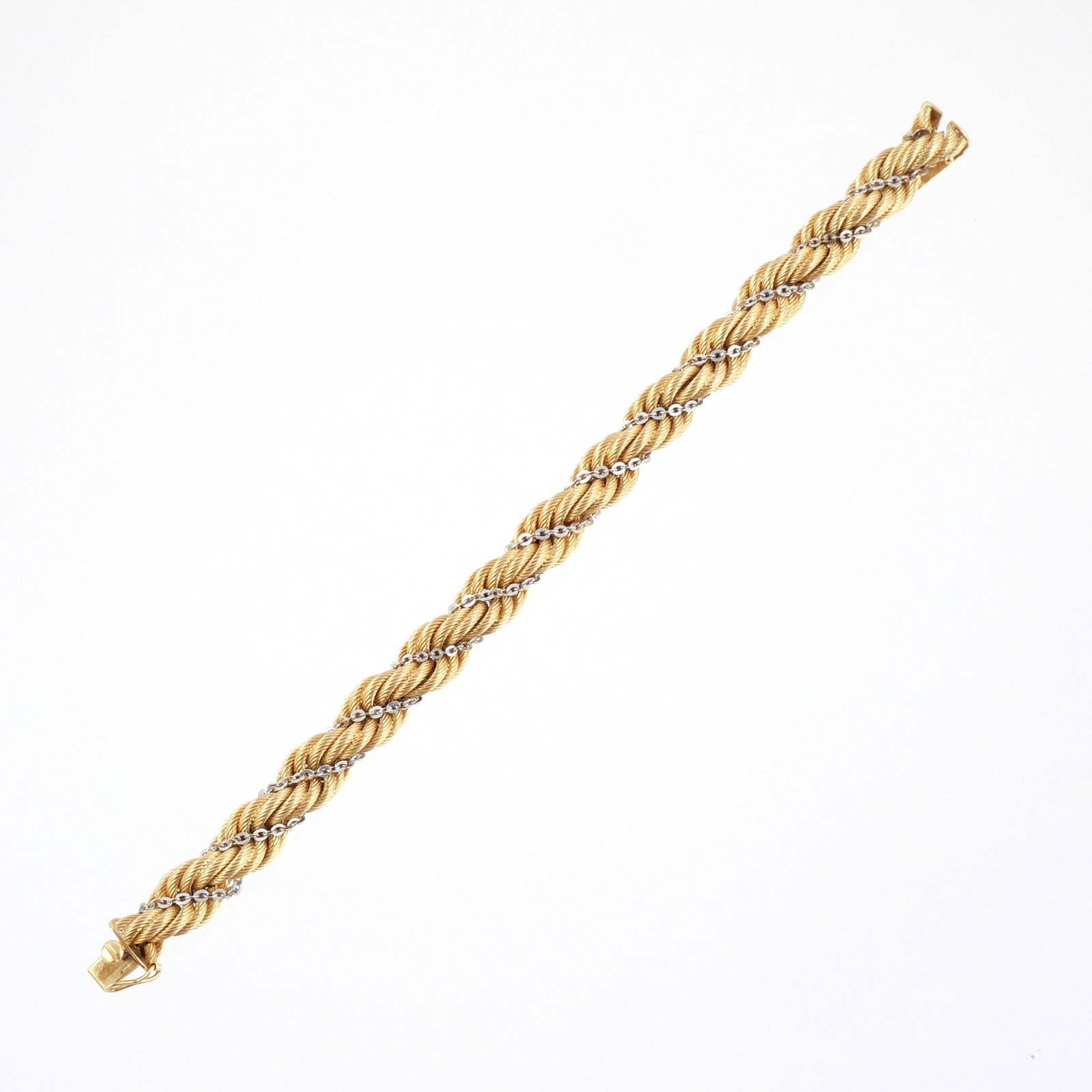 18K TWO-TONE ITALIAN GOLD ROPE BRACELET: Composed of a textured yellow gold rope interwoven with a white gold link chain, marked '750' with Italian registration mark possibly '113 TO', l. 7-1/2 in., 29.6 g w. 3/8 in. Provenance: Descent thro
