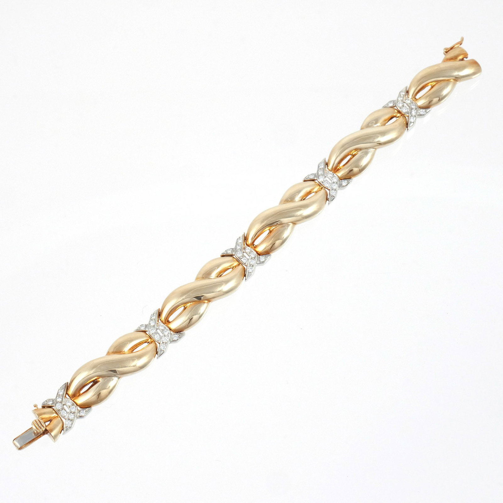 14K GOLD and DIAMOND BRACELET: Polished gold infinity style links with melee diamond connectors, signed 'Pebbles' and marked '14k', l. 7 in., 33.3 g total weight w. 1/2 in. Provenance: Descent through the consignor's family