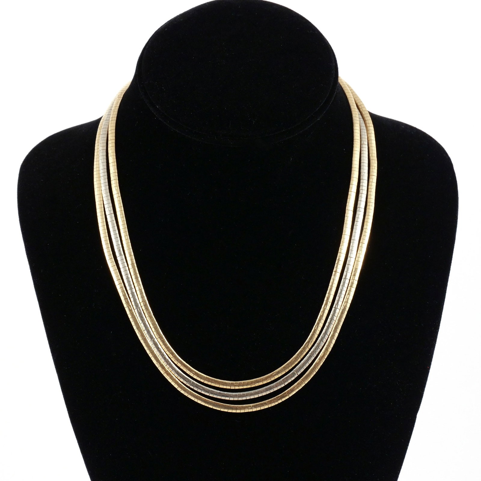 18K TWO-TONE ITALIAN GOLD 3-STRAND NECKLACE: Comprised of one 18k white gold and two 18k yellow gold strands, marked 'K18 / Italy' and Italian registry mark '364 VI' for Giuseppe Bicego, l. 18 in., 60 g total weight Provenance: The estate of a n