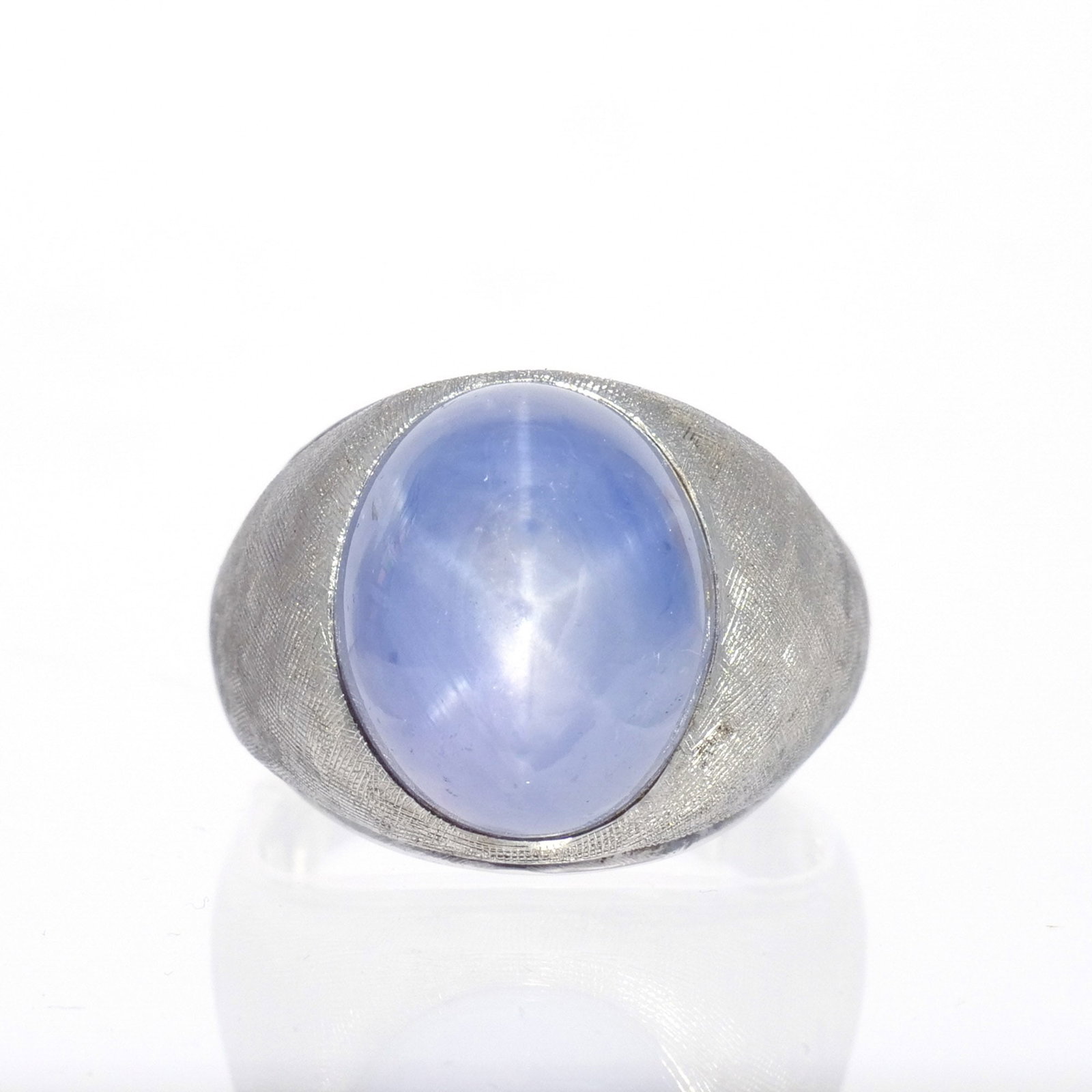 14K WHITE GOLD STAR SAPPHIRE MEN'S RING: Approx. 40 ct star sapphire mounted in florentine finish white gold, marked '14k', size 12-3/4 with ring sizer, 35 g total weight w. 3/4 in. Provenance: Descent through the consignor's family