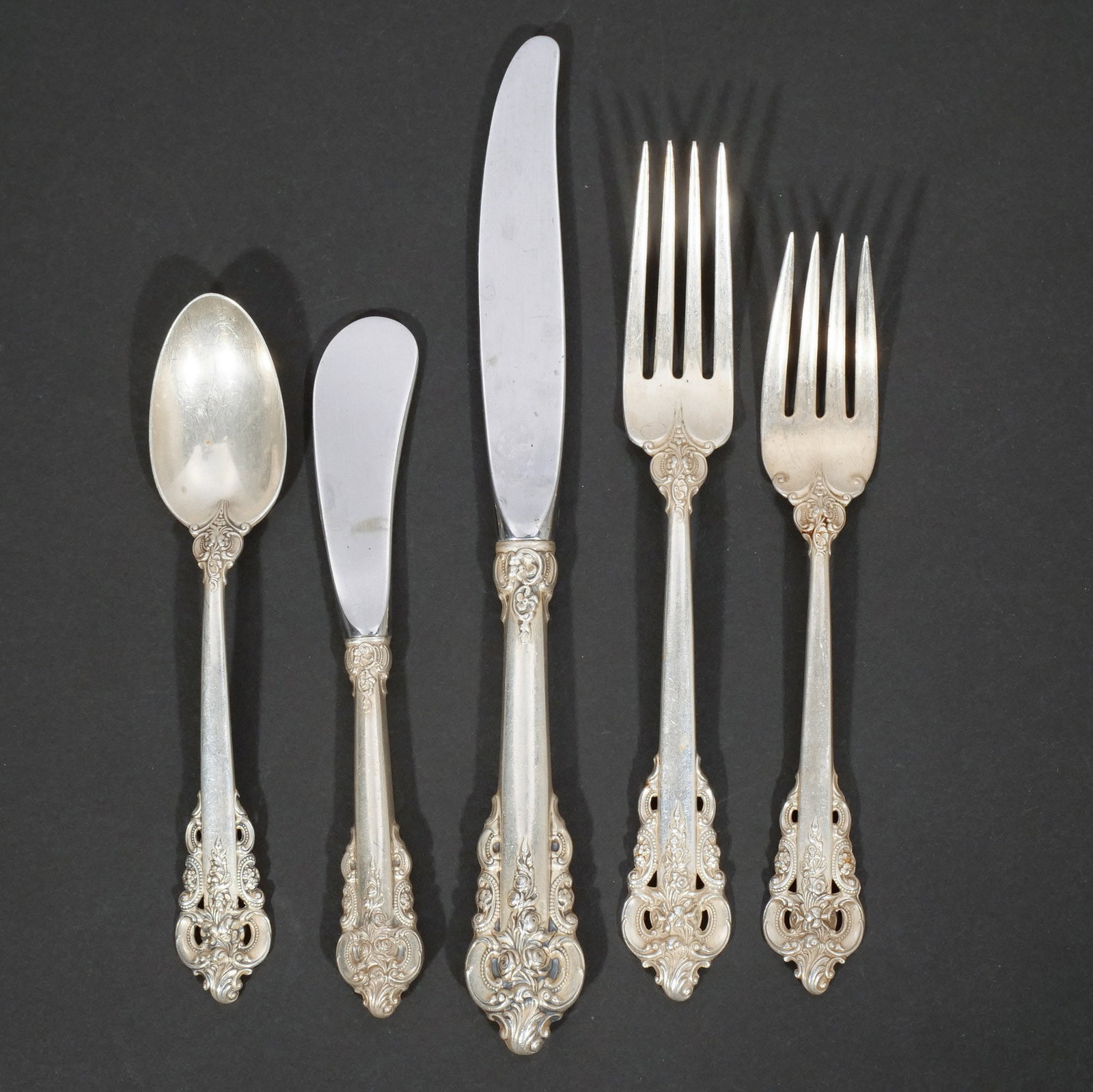 (74pc) WALLACE STERLING SILVER FLATWARE SERVICE: In the 'Grand Baroque' pattern, circa 1941; comprising 12 dinner forks, 10 dessert forks, 24 teaspoons, 12 luncheon knives, 12 butter knives, 1 cheese knife, 1 pickle fork, 1 tablespoon, and 1
