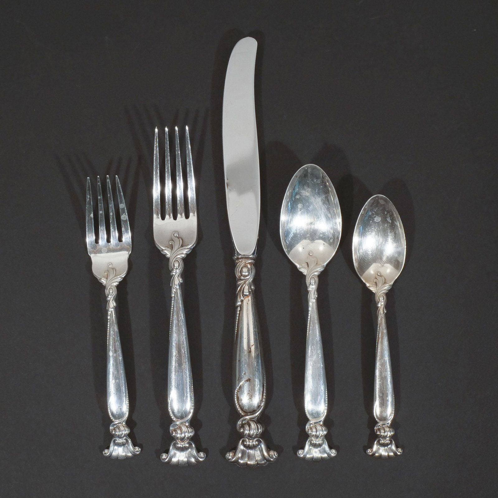 (85pc) WALLACE STERLING SILVER FLATWARE SERVICE: In the 'Romance of the Sea' pattern, including 17 dinner forks, 14 salad forks, 18 soup spoons, 18 teaspoons, and 18 dinner knives, 179 ozt total weight h. 10 in. (longest) Provenance: Private