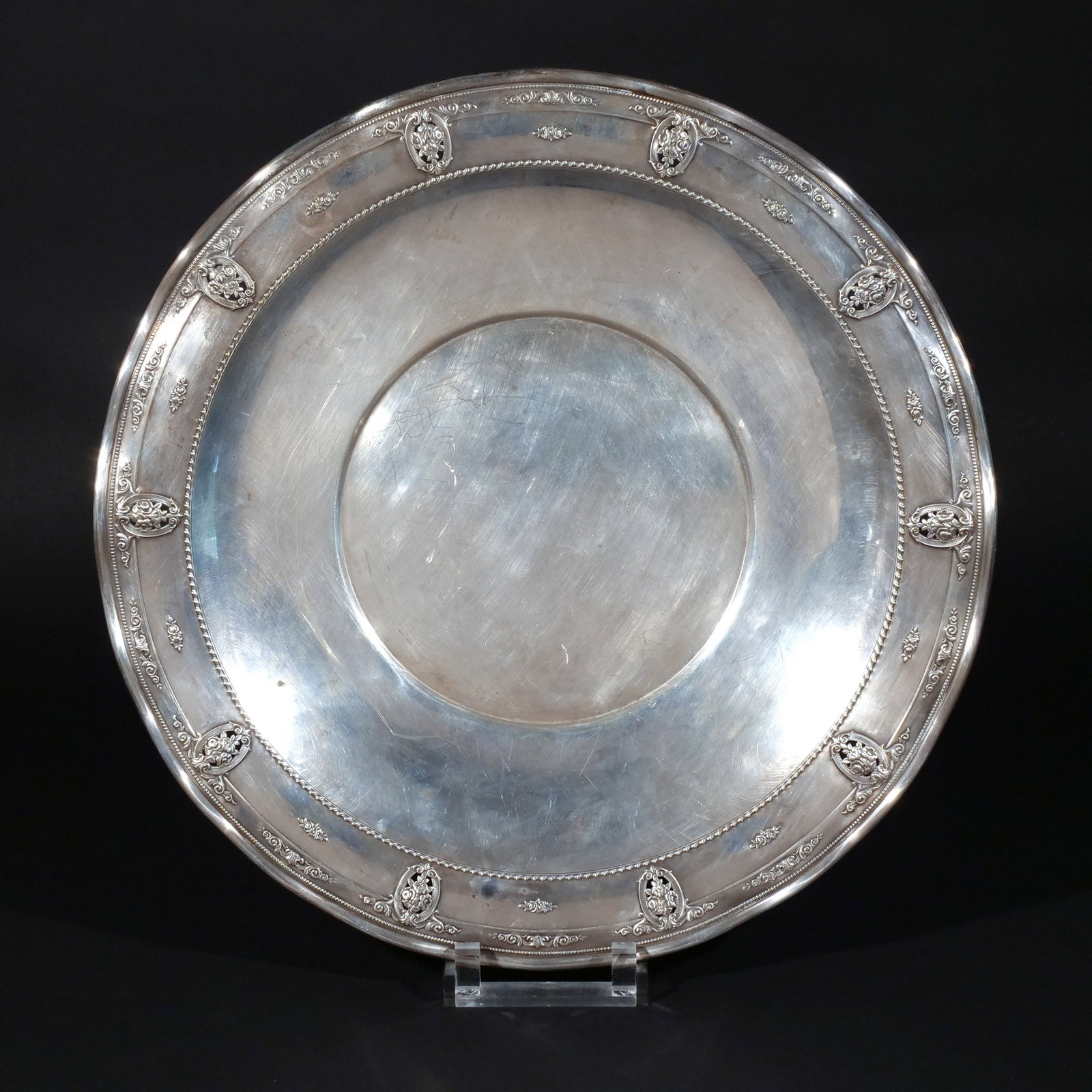 LARGE WALLACE STERLING CIRCULAR TRAY: In the 'Rose Point De Luxe' pattern, with wavy edges and pierced classical cartouches, 41 ozt dia. 17-1/4 in. Provenance: The estate of Richard and Jean M. Bergstresser, owner of the Laurence McGuire