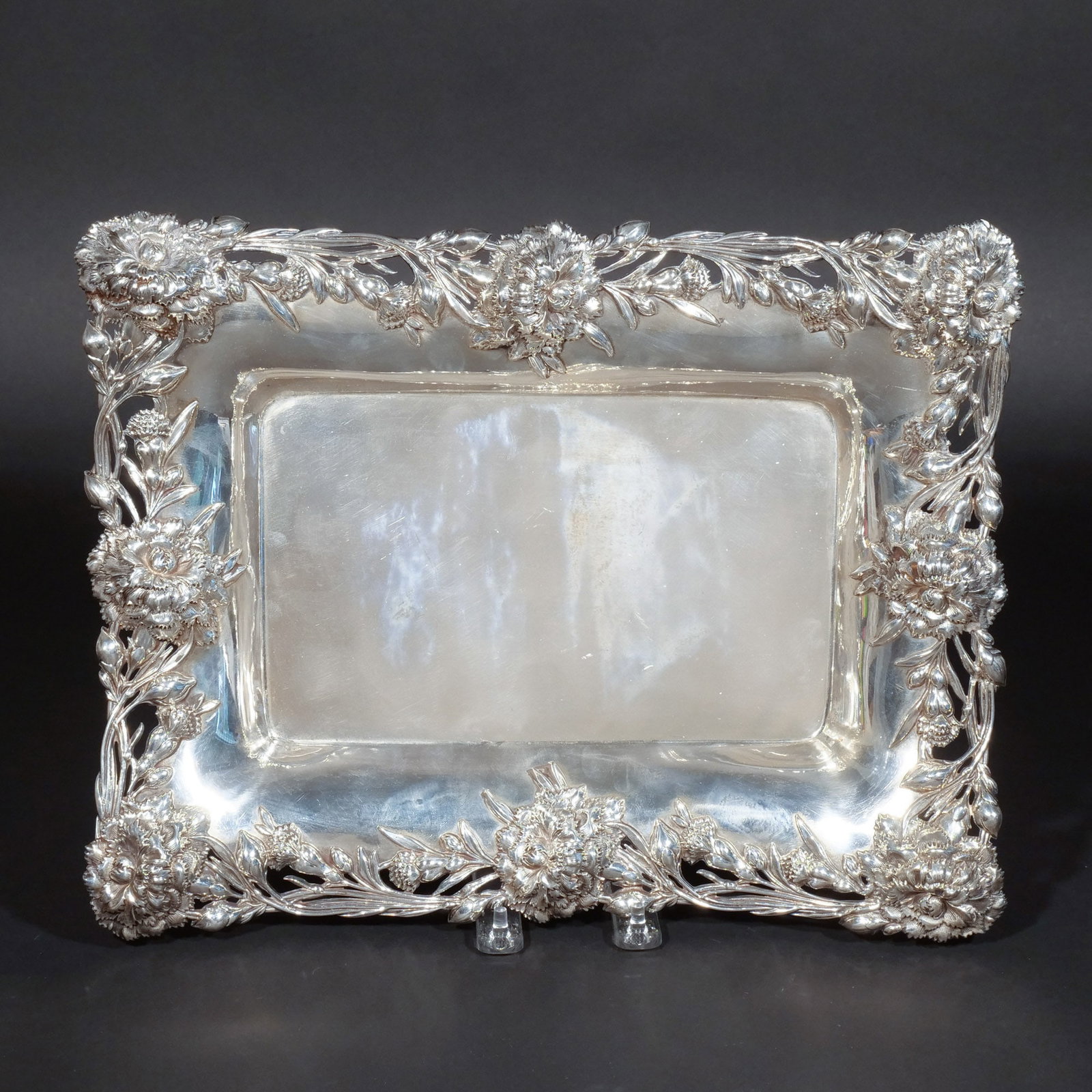 J.E. CALDWELL & CO. STERLING SILVER TRAY: With raised floral and foliate border, maker's mark and stamped '925 / Sterling', 36 ozt h. 11-1/2 w. 14-1/2 d. 2-1/4 in. Provenance: Private collection, Mount Kisco, NY [In Situ Item] This item will