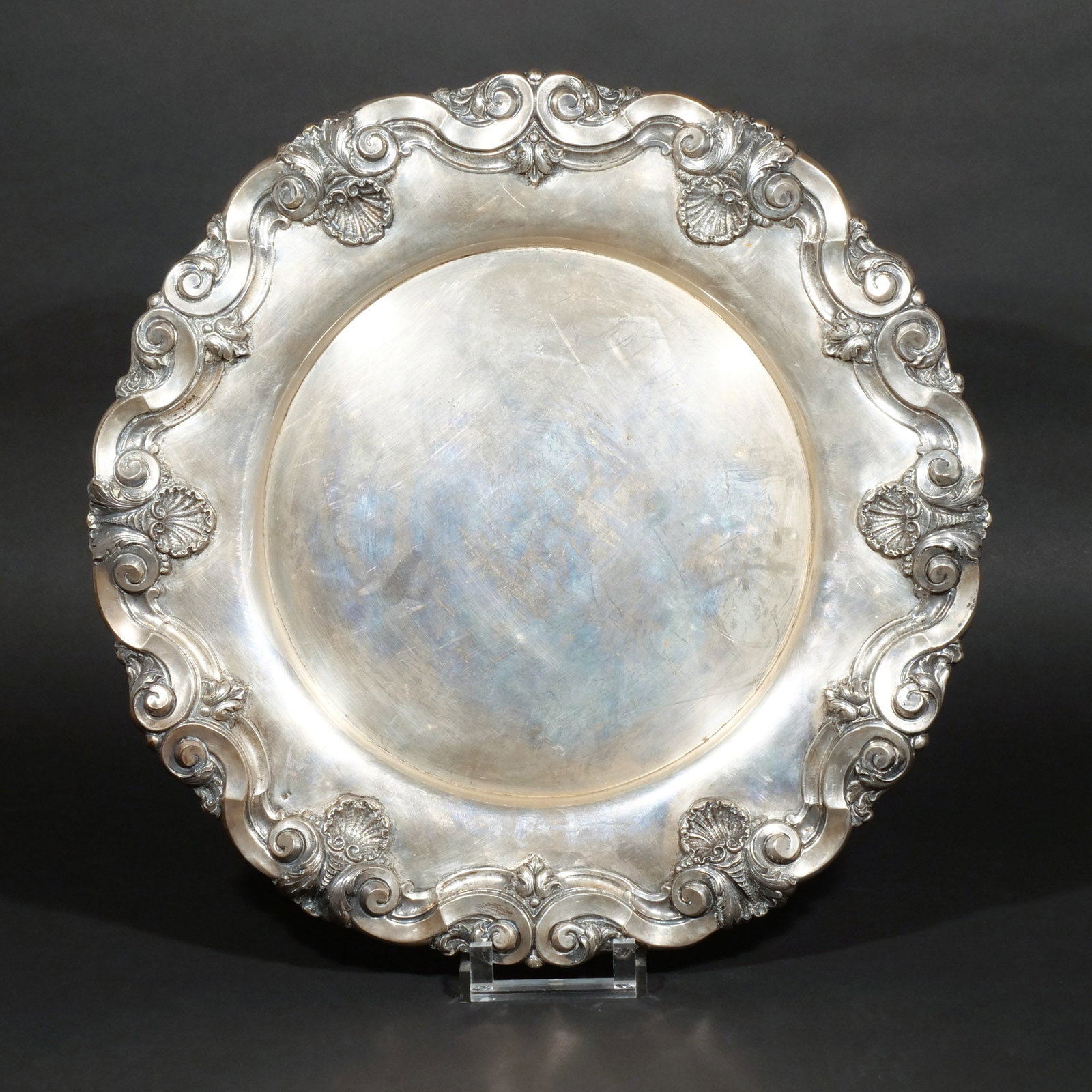 PORTUGUESE .833 SILVER CHARGER: Lobed with scrollwork and shell design, with hallmarks, fitted on reverse with a screw for hanging, 59 ozt dia. 19-1/4 in. Provenance: The estate of a noted architect and bibliophile, Rye, NY [In Situ