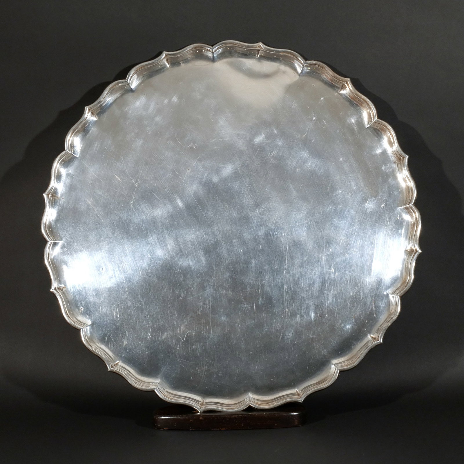 MASSIVE FRENCH STERLING SILVER CHARGER: 18th century, with scalloped edges, French assay marks, with later wood table base for us as a coffee table, 142 ozt dia. 28-1/2 in. Provenance: Descent through a prominent Greenwich, CT doctor's esta