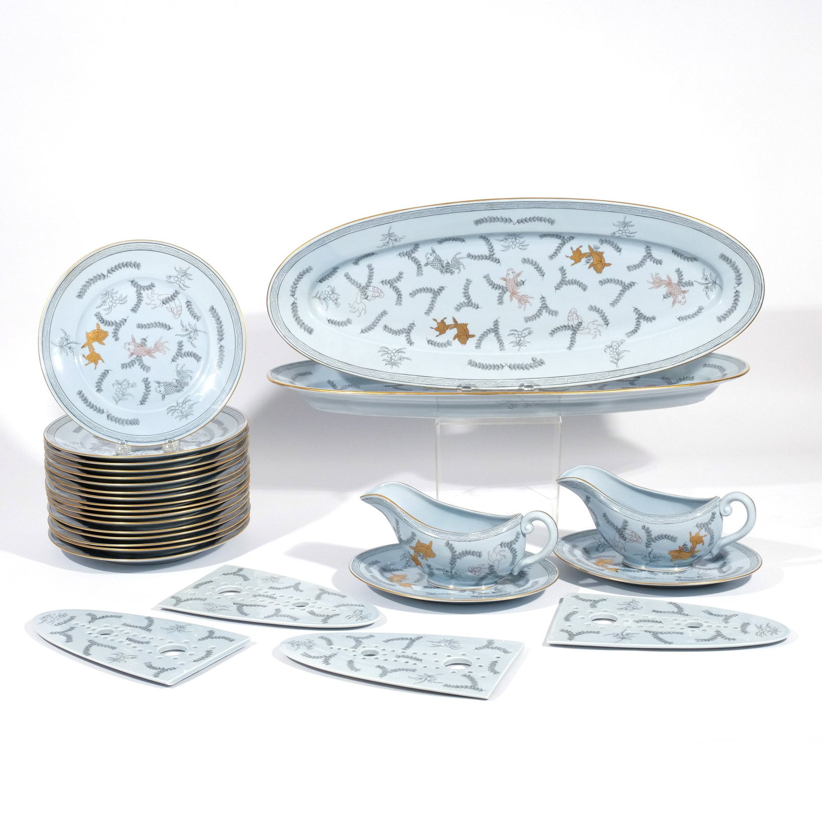 (23pc) RARE HEREND 'POISSON' FISH SET: Including 17 fish plates, 2 small oval platters, 2 large platters each with 2 two-piece strainers, and 2 gravy boats with underplates; all in a rare colorway of black outline, gilt, and red on a