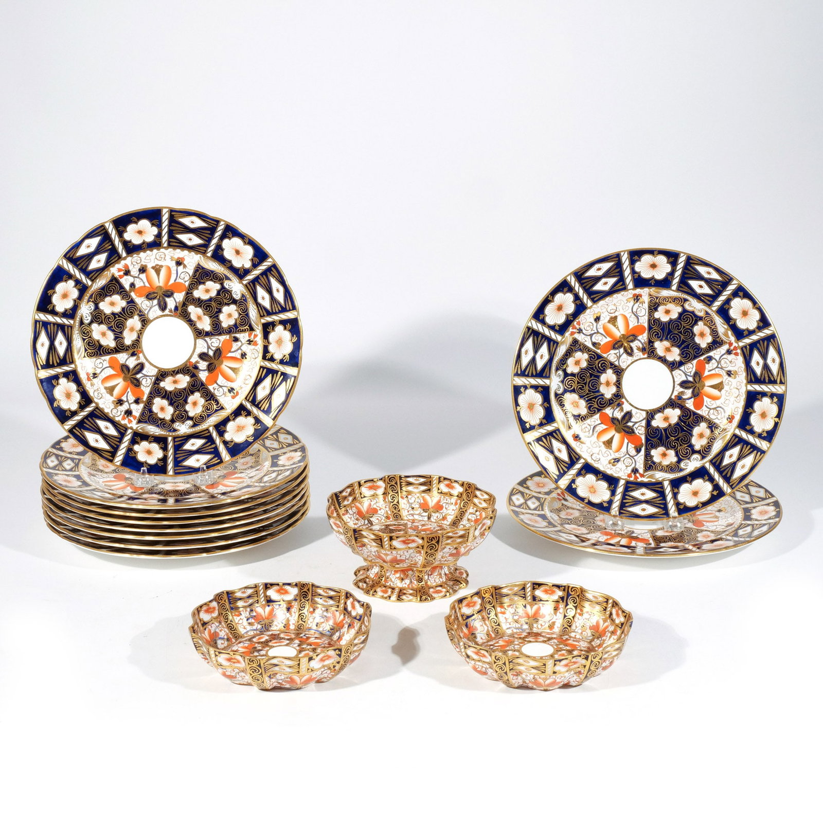 (13pc) ROYAL CROWN DERBY IMARI DINNERWARE: Traditional Imari pattern, including 2 dinner plates, 8 luncheon plates, 2 low bowls, and 1 footed bowl dia. 10-3/8 in. (largest) Provenance: The estate of Richard and Jean M. Bergstresser, owner of