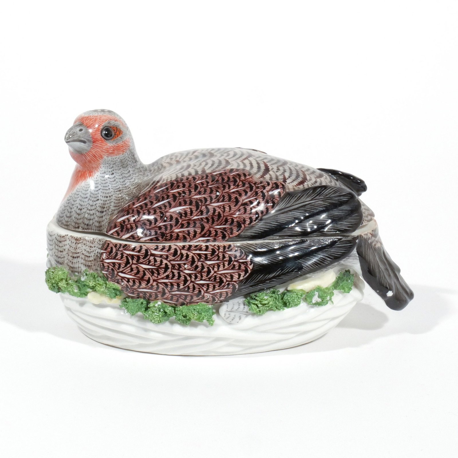 RARE PORCELAIN 'QUAIL' TUREEN & COVER: Circa 1760-70, English or possibly Meissen, well modeled and enameled in the form of a partridge crouching in its nest, with small crossed swords mark h. 4-1/2 w. 7 d. 4 in. Provenance: D. M. & P.