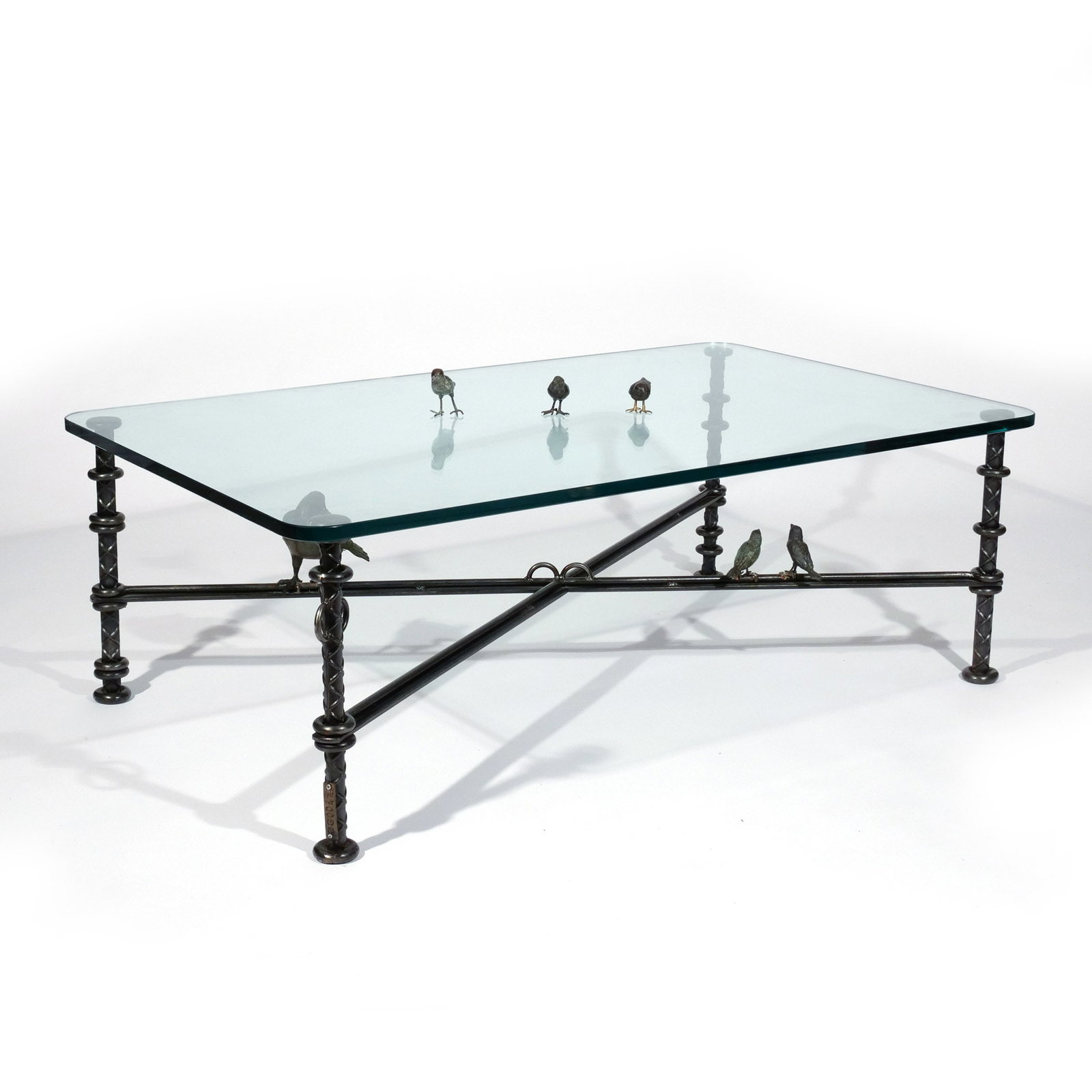 ILANA GOOR (Israeli, b. 1936): Iron and bronze coffee table with glass top, having an X-form stretcher with birds perched along it, signed and numbered 11/100, with three additional loose bronze bird figures to be placed above the