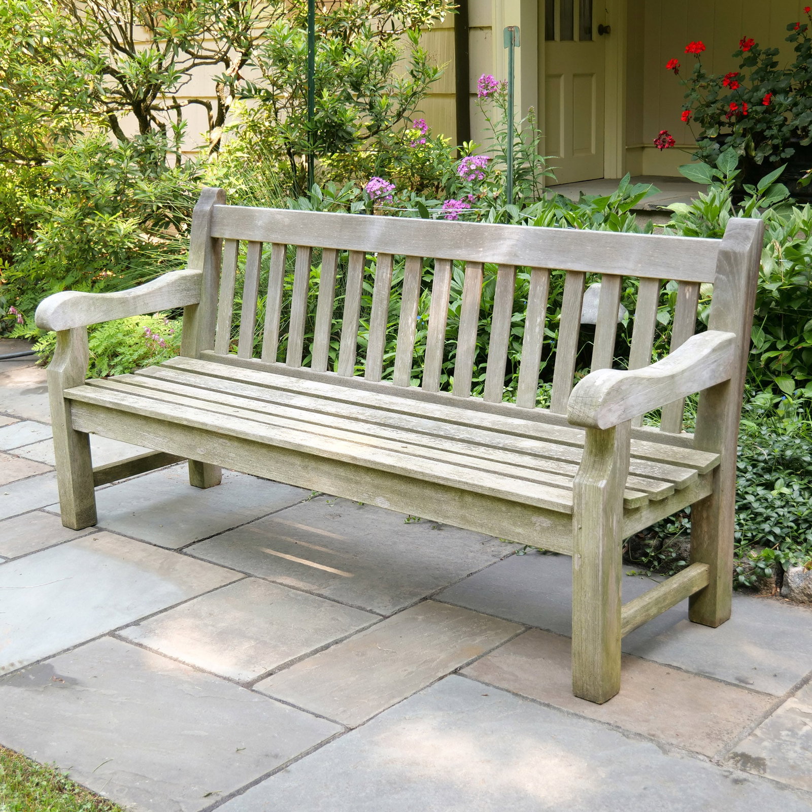 BARLOW TYRIE OUTDOOR TEAKWOOD BENCH: With slat back and seat h. 36 w. 72 d. 24 in. Provenance: Landmark Hoyt Homestead, Pound Ridge, NY [In Situ Item] This item will not be on display in our saleroom during our preview period. If you