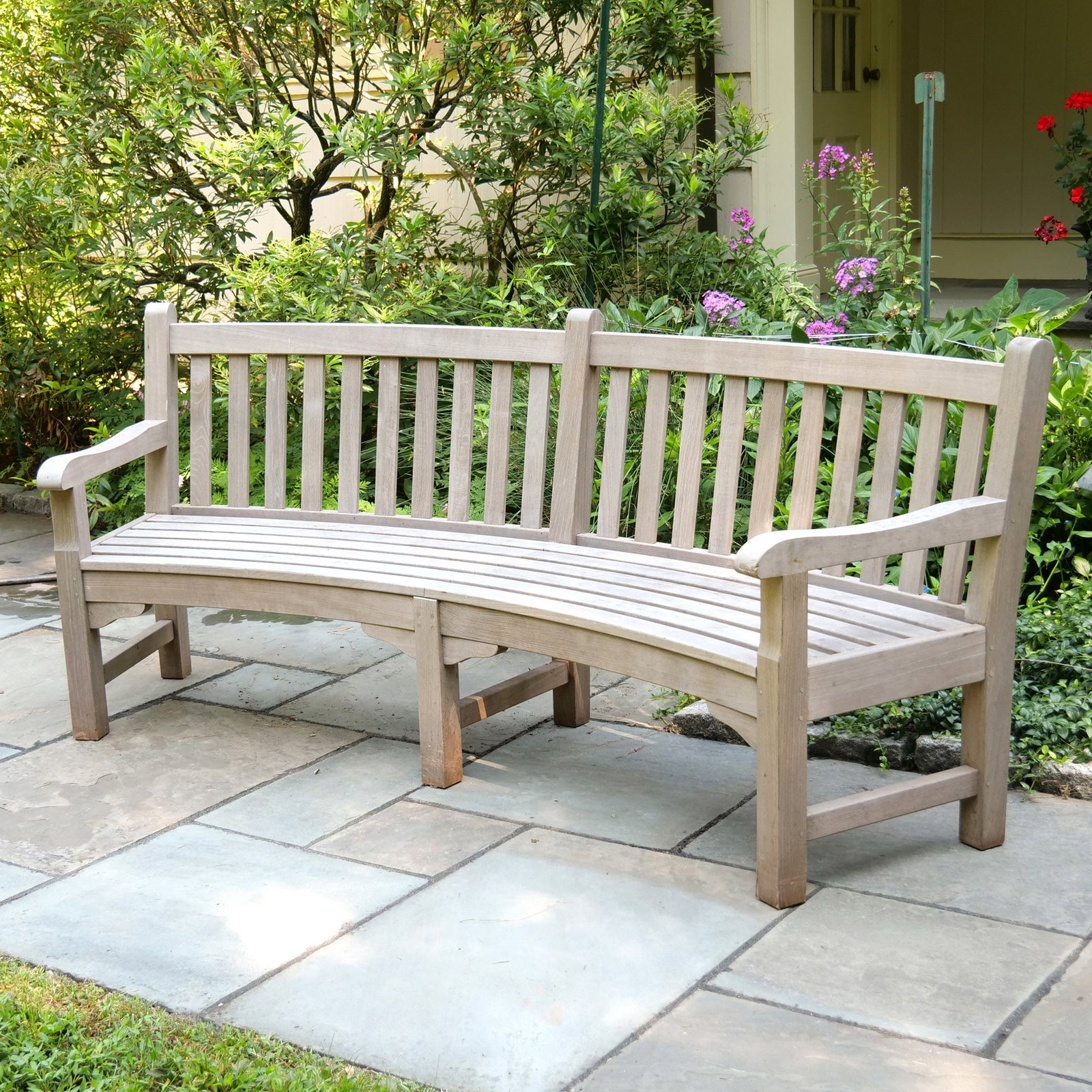 BARLOW TYRIE GLENHAM CURVED TEAKWOOD BENCH: With slat back and seat h. 35-1/2 w. 88 d. 20 in. Provenance: Landmark Hoyt Homestead, Pound Ridge, NY [In Situ Item] This item will not be on display in our saleroom during our preview period. If