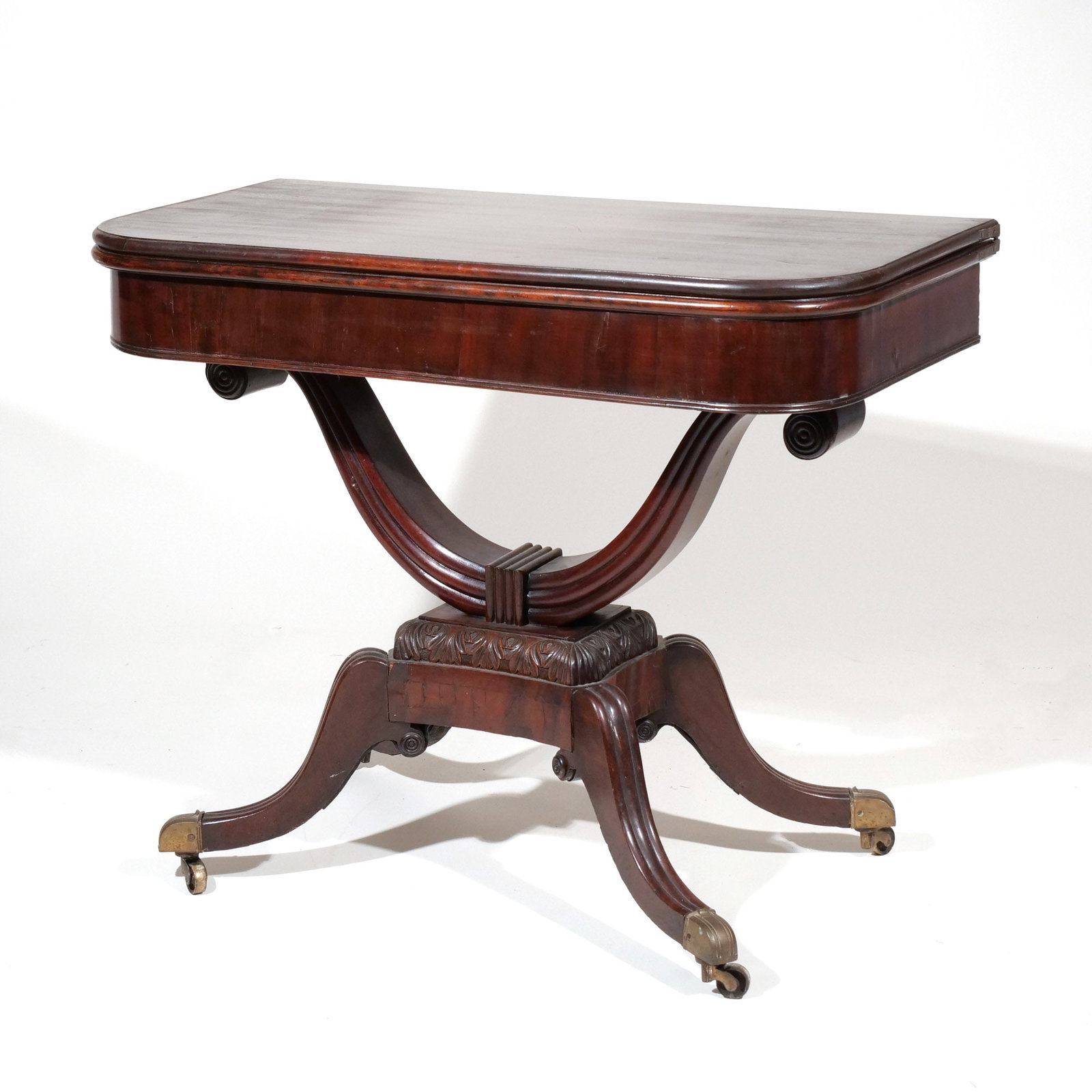 AMERICAN CLASSICAL WISHBONE BASE GAMESTABLE: Mid 19th century, having wishbone pedestal resting on platform supported by quadruped scroll legs ending in pad feet with brass caps, velvet interior, locking mechanism h. 29-1/2 w. 36-1/2 d. 18-1/2