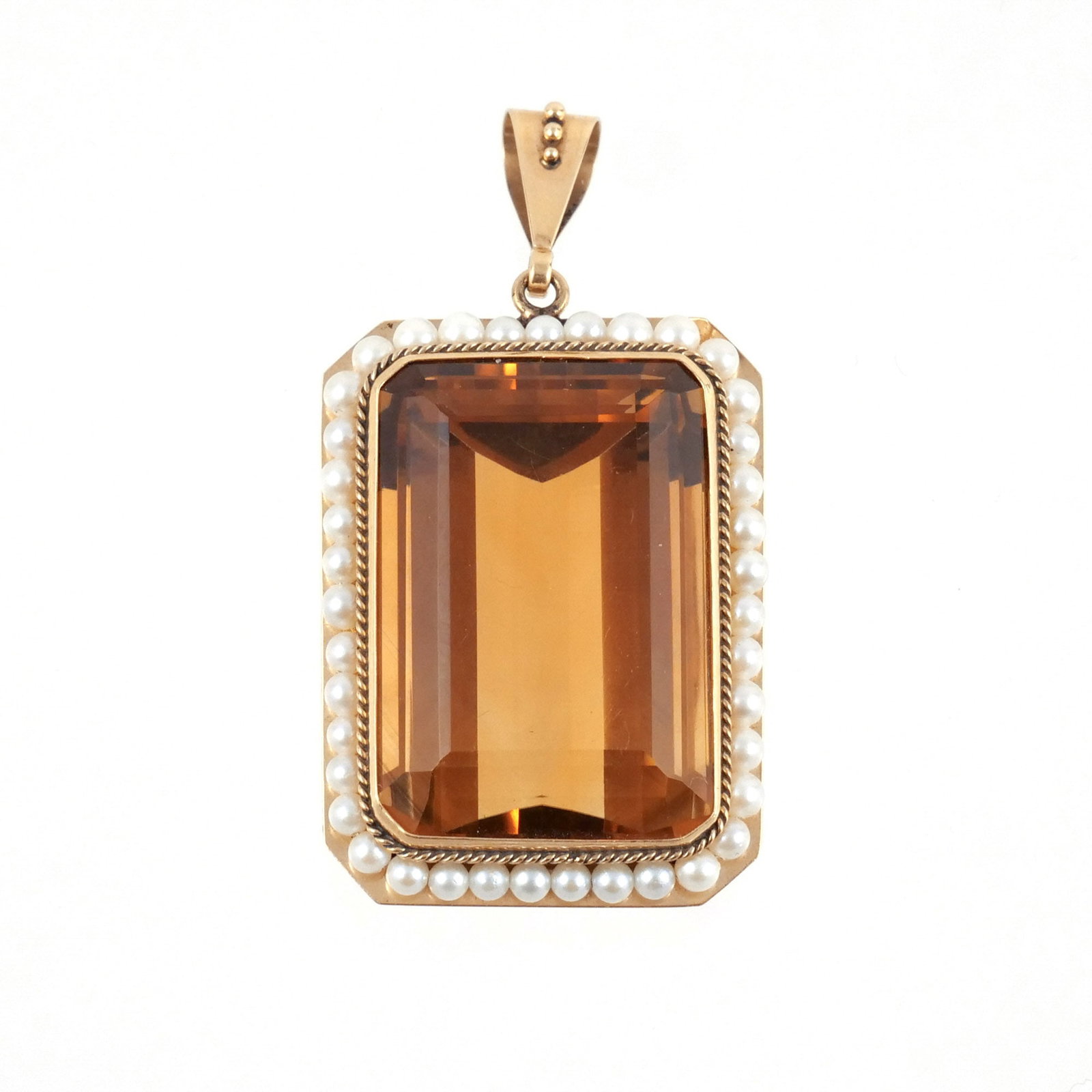 14K GOLD, CITRINE, and PEARL PENDANT: Centering an approx. 63 ct emerald cut citrine surrounded by rope gold and seed pearls, marked '14k' with indistinct maker's mark, 23.2 g total weight h. 1-1/2 w. 1 in. overall: 2 x 1 in. (with bale)