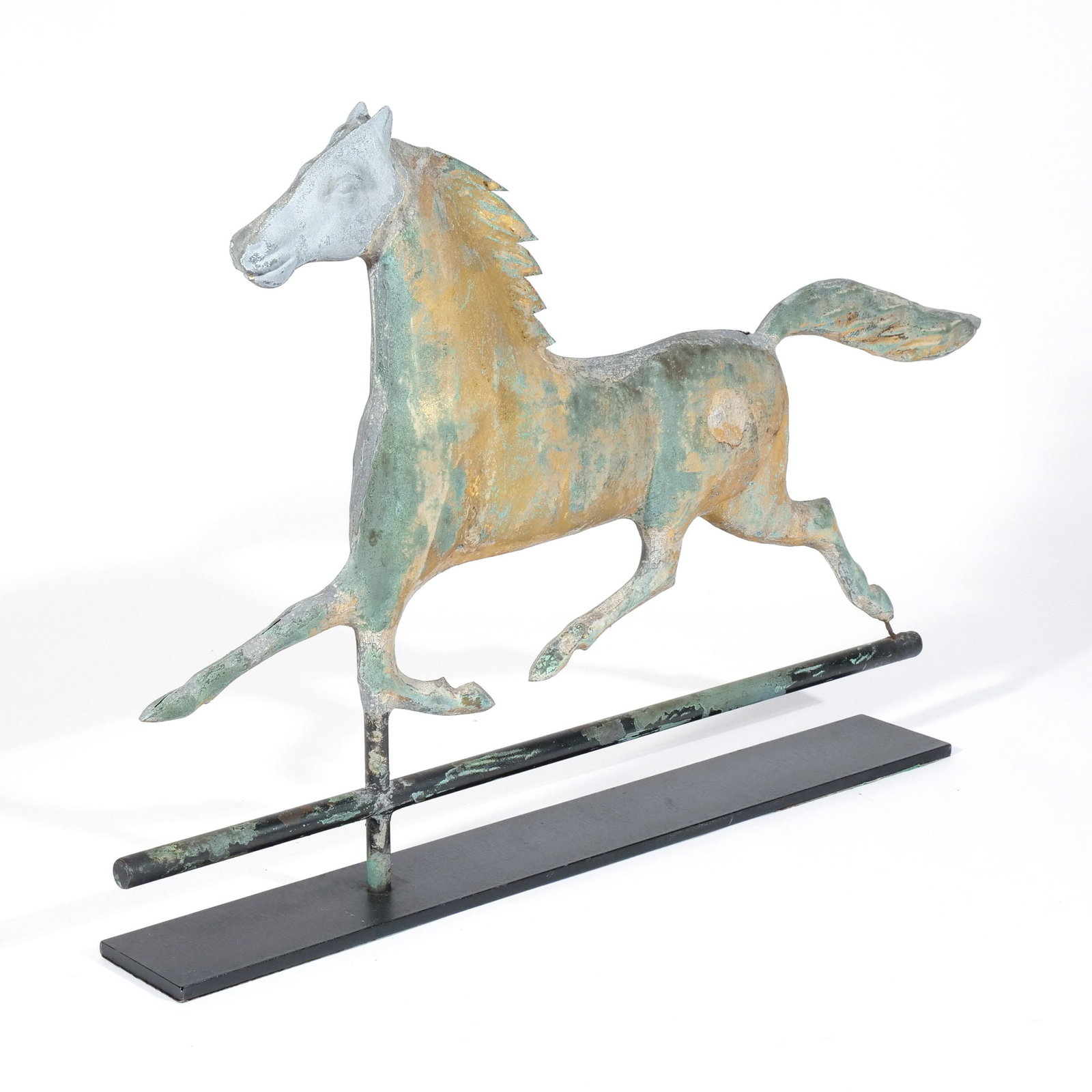 AMERICAN FULL-BODIED RUNNING HORSE WEATHERVANE: c. 1900, with gilt finish, zinc head, on a metal stand h. 16-1/2 w. 26-1/2 d. 3 in. (with stand) Provenance: Descent through the family of the consignor