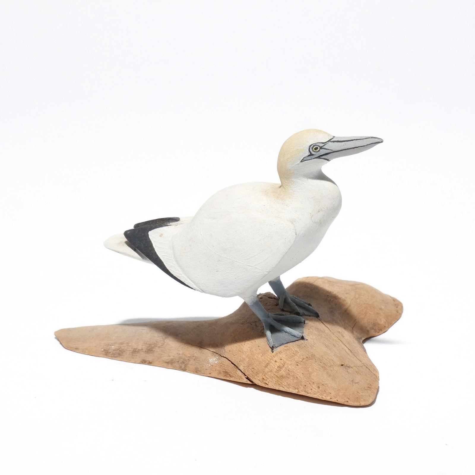 HAROLD GIBBS (1886-1970) NORTHERN GANNET: Carved miniature, mounted on a driftwood base, signed with conjoined 'HNG' on underside h. 2-1/2 w. 3-5/8 d. 3 in. (overall) Provenance: Descended through the estate of U.S. Ambassador James C. H. Bon
