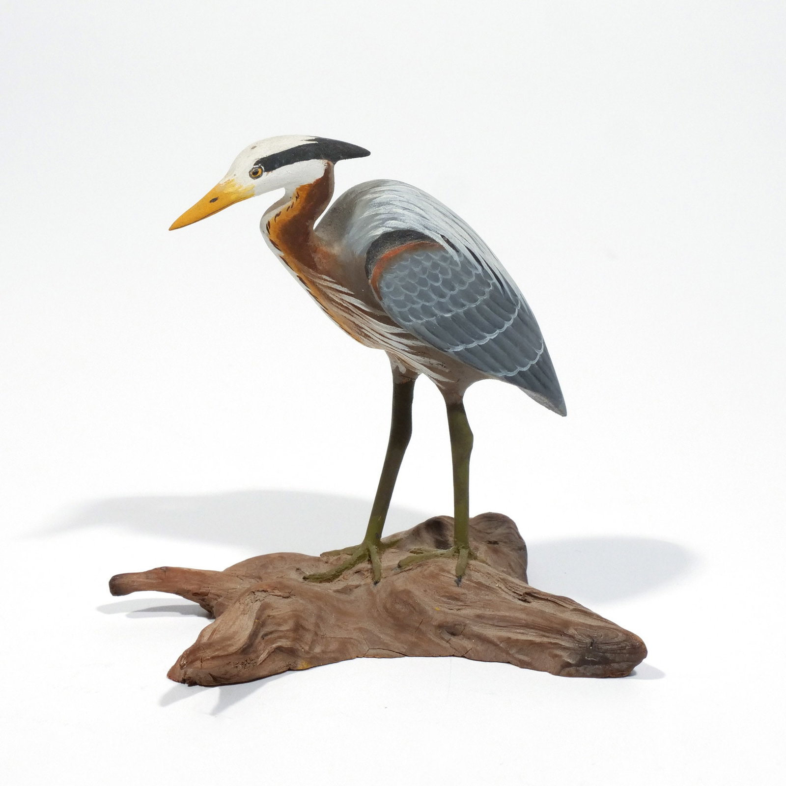 HAROLD GIBBS (1886-1970) GREAT BLUE HERON: Carved miniature, mounted on a driftwood base, signed 'H. Gibbs' on underside h. 3-3/4 w. 3-1/2 d. 2-7/8 in. (overall) Provenance: Descended through the estate of U.S. Ambassador James C. H. Bonbright