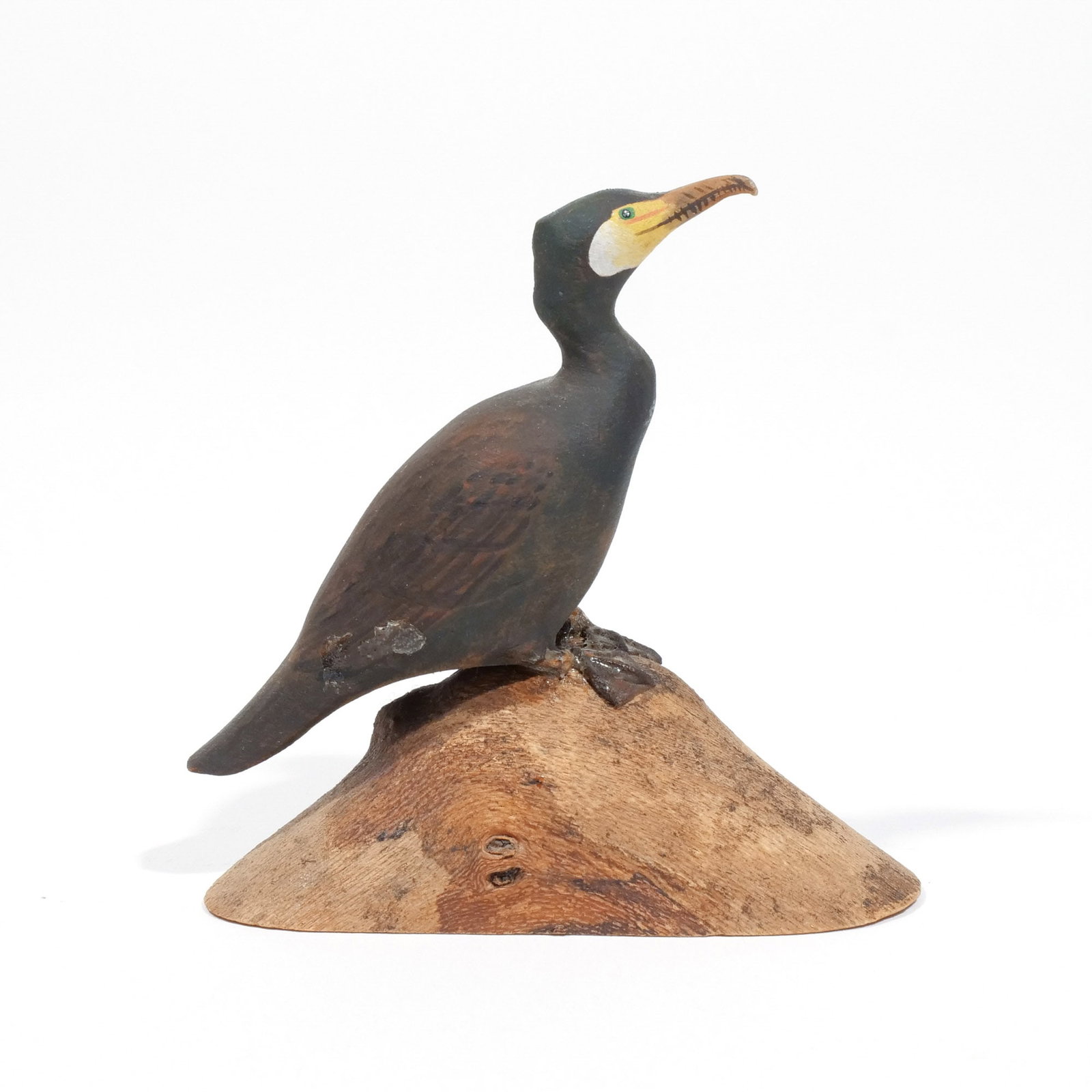 HAROLD GIBBS (1886-1970) CORMORANT: Carved miniature, mounted on a driftwood base, signed with conjoined 'HNG' and inscribed 'Cormorant' on underside h. 3 w. 2-7/8 d. 1-1/4 in. (overall) Provenance: Descended through the estate of U.S. 