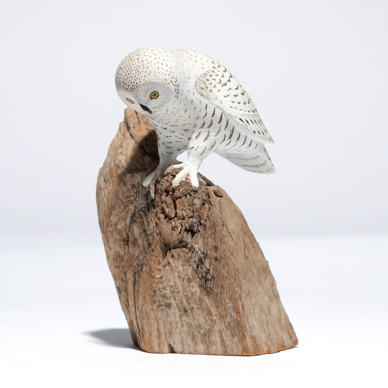 HAROLD GIBBS (1886-1970) SNOWY OWL: Carved miniature, mounted on a driftwood base, signed with conjoined 'HNG' on underside h. 4 w. 2-1/4 d. 2-1/2 in. (overall) Provenance: Descended through the estate of U.S. Ambassador James C. H. Bon