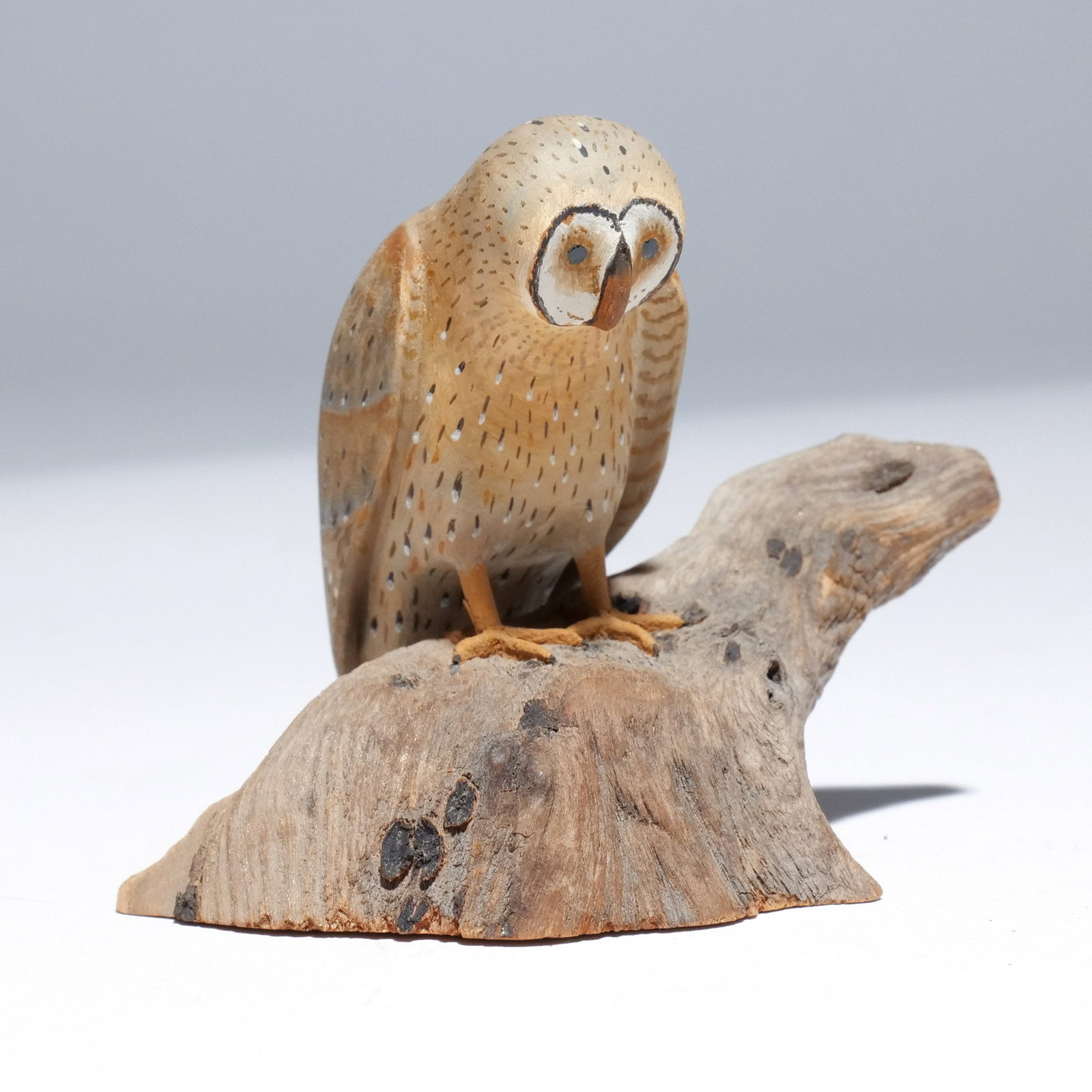 HAROLD GIBBS (1886-1970) BARN OWL: Carved miniature, mounted on a driftwood base, signed with conjoined initials 'HNG' and dated '1958' on underside h. 3 w. 4 d. 2-1/2 in. (overall) Provenance: Descended through the estate of U.S. Amba